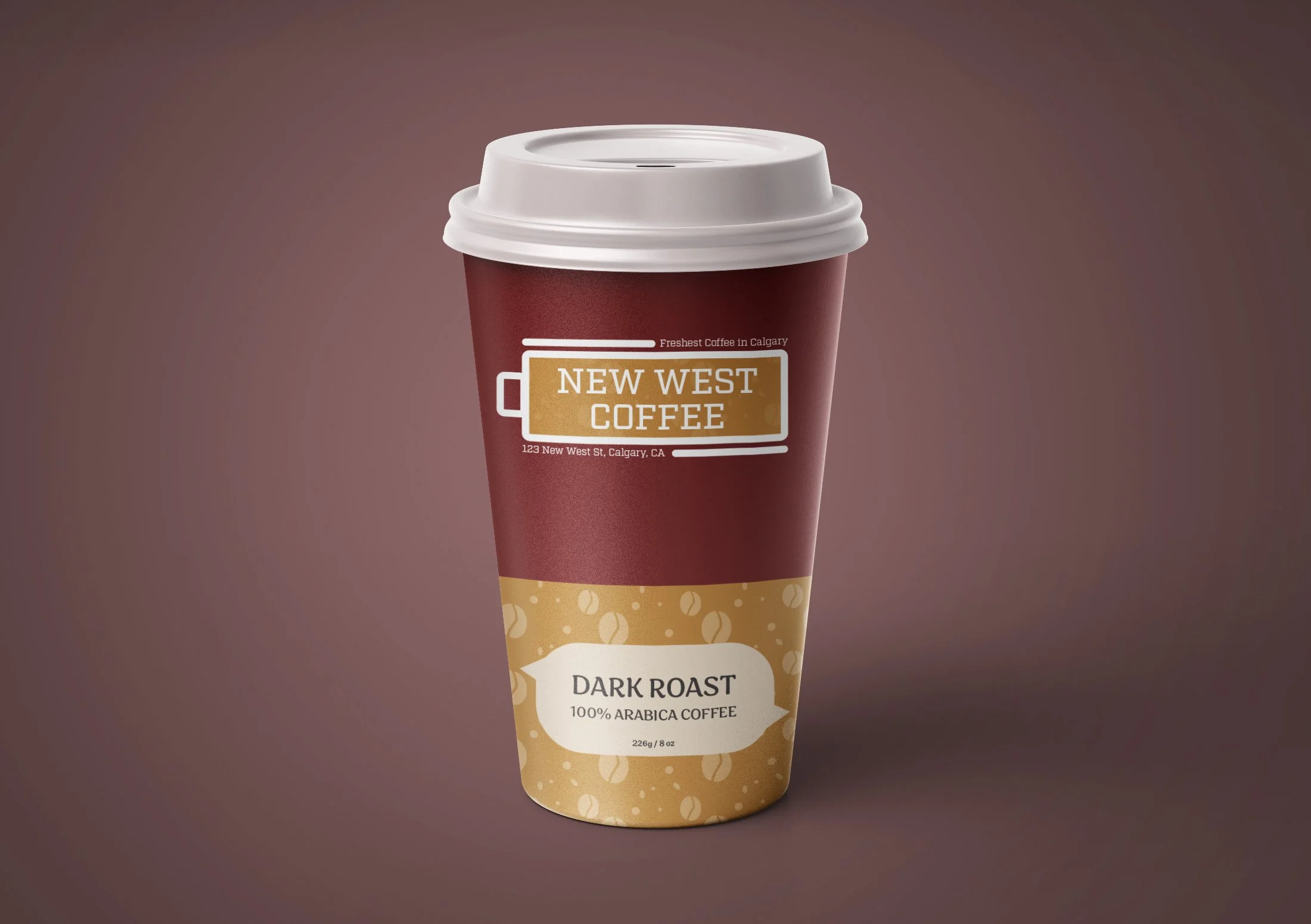 A coffee cup with a white lid and a maroon body, labeled 'New West Coffee,' featuring text indicating it's dark roast 100% Arabica coffee from Calgary, Alberta.