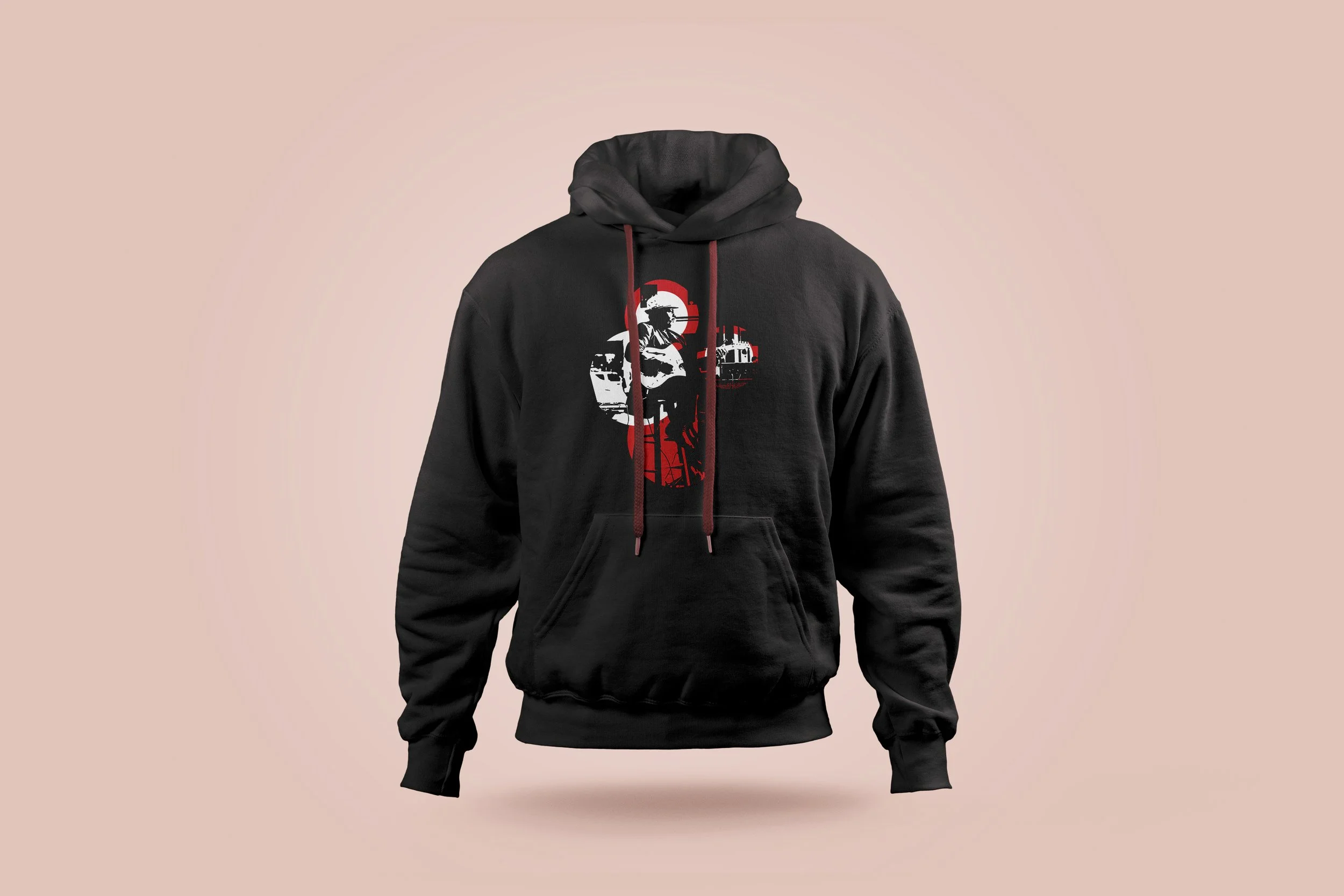 Black hoodie with a graphic of a person playing guitar and an industrial background, set against a light pink background.