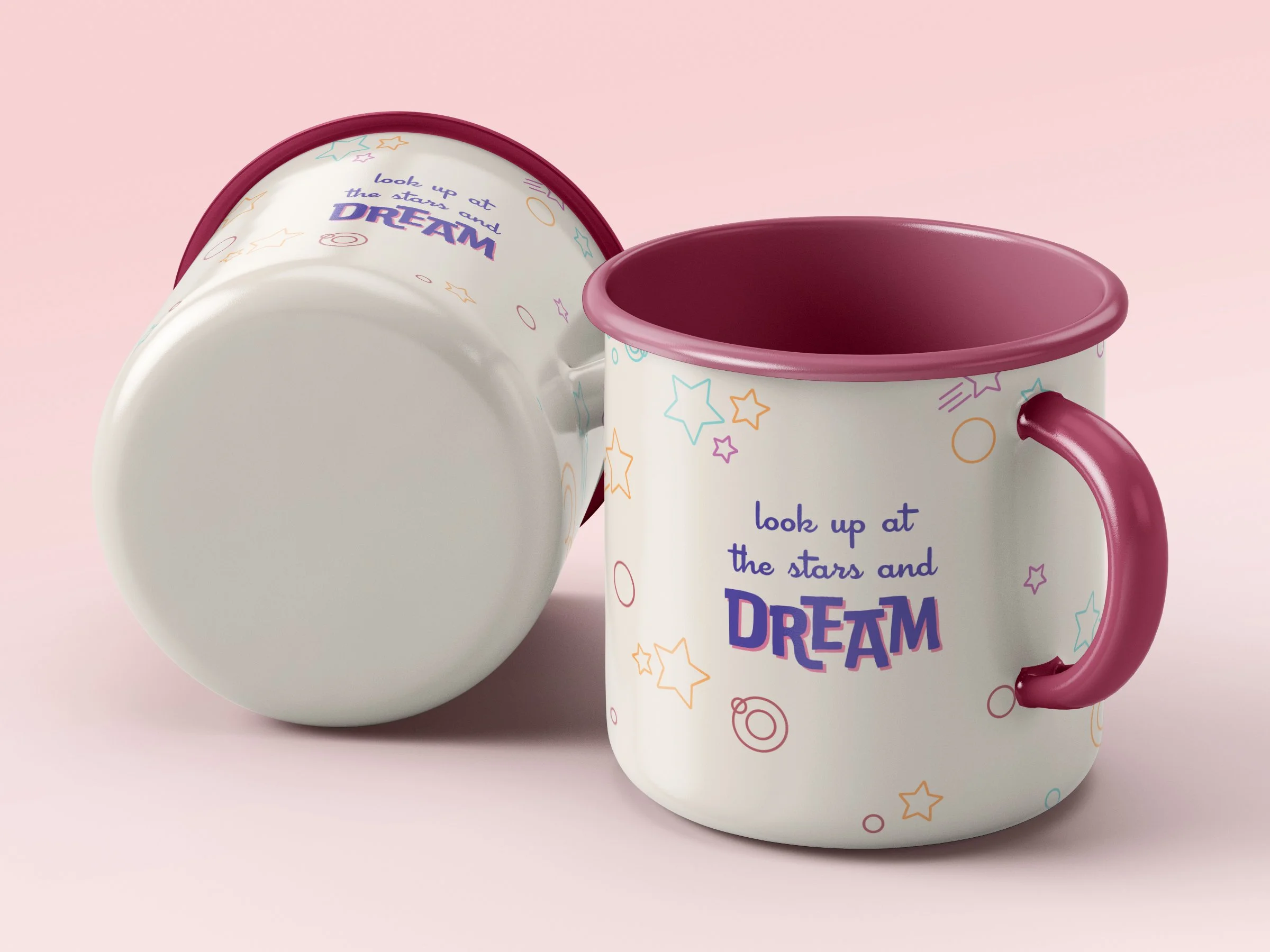 A white mug with colorful star and circle patterns, pink rim and handle, displaying the text 'look up at the stars and DREaM' in purple and pink, placed next to a white bowl with similar star patterns, both set against a soft pink background.