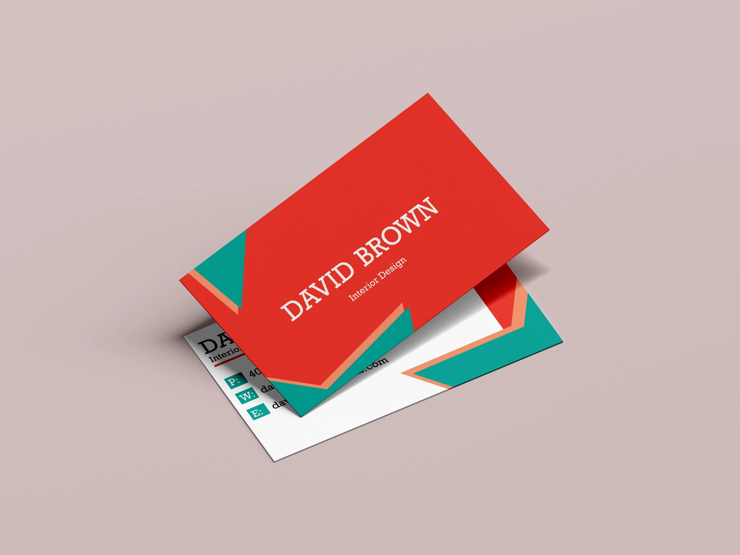 Business cards for David Brown, an interior designer, are layered on top of each other on a light pink background.
