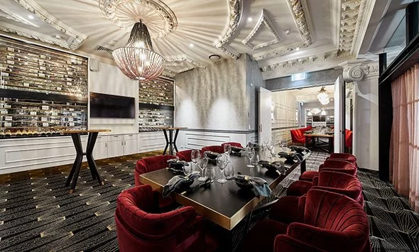 Donna Chang private dining room interior with chandeliers and red chairs