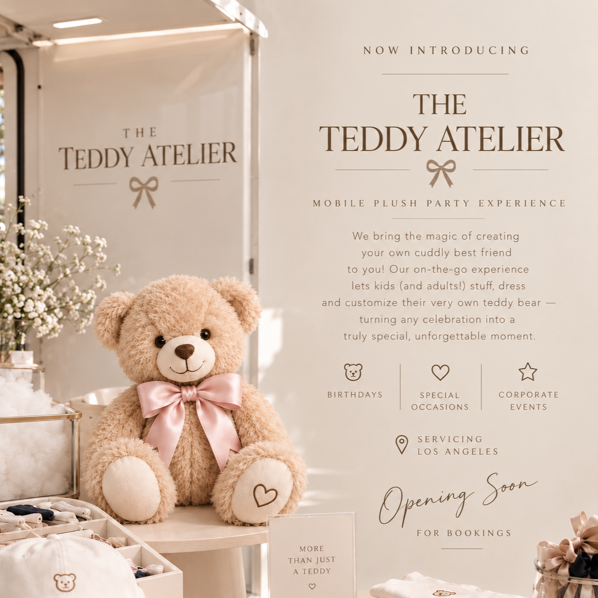 A plush teddy bear with a pink satin bow around its neck sitting on a display table at the Teddy Atelier, a mobile plush party service, with a white background and promotional poster nearby.
