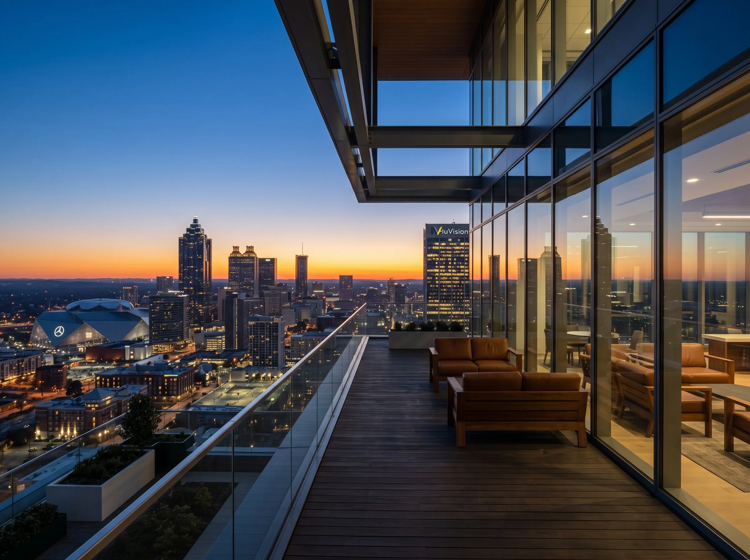 Modern executive terrace and lounge overlooking high-rise city architecture at twilight.