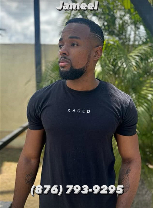 A man with short black hair and a beard, wearing a black t-shirt with the word 'KAGED' printed on it, standing outdoors with greenery in the background. Text overlay says 'Jameel' at the top and a phone number '(876) 793-9295' at the bottom.