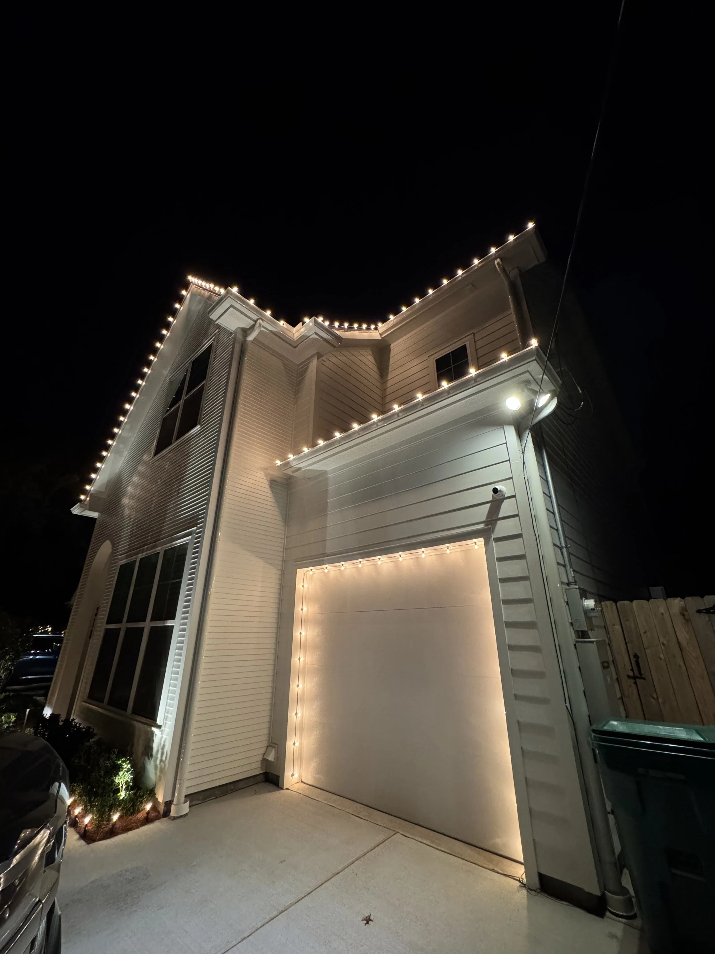 warm-white-christmas-lights-two-story-home-garage-door.jpg
