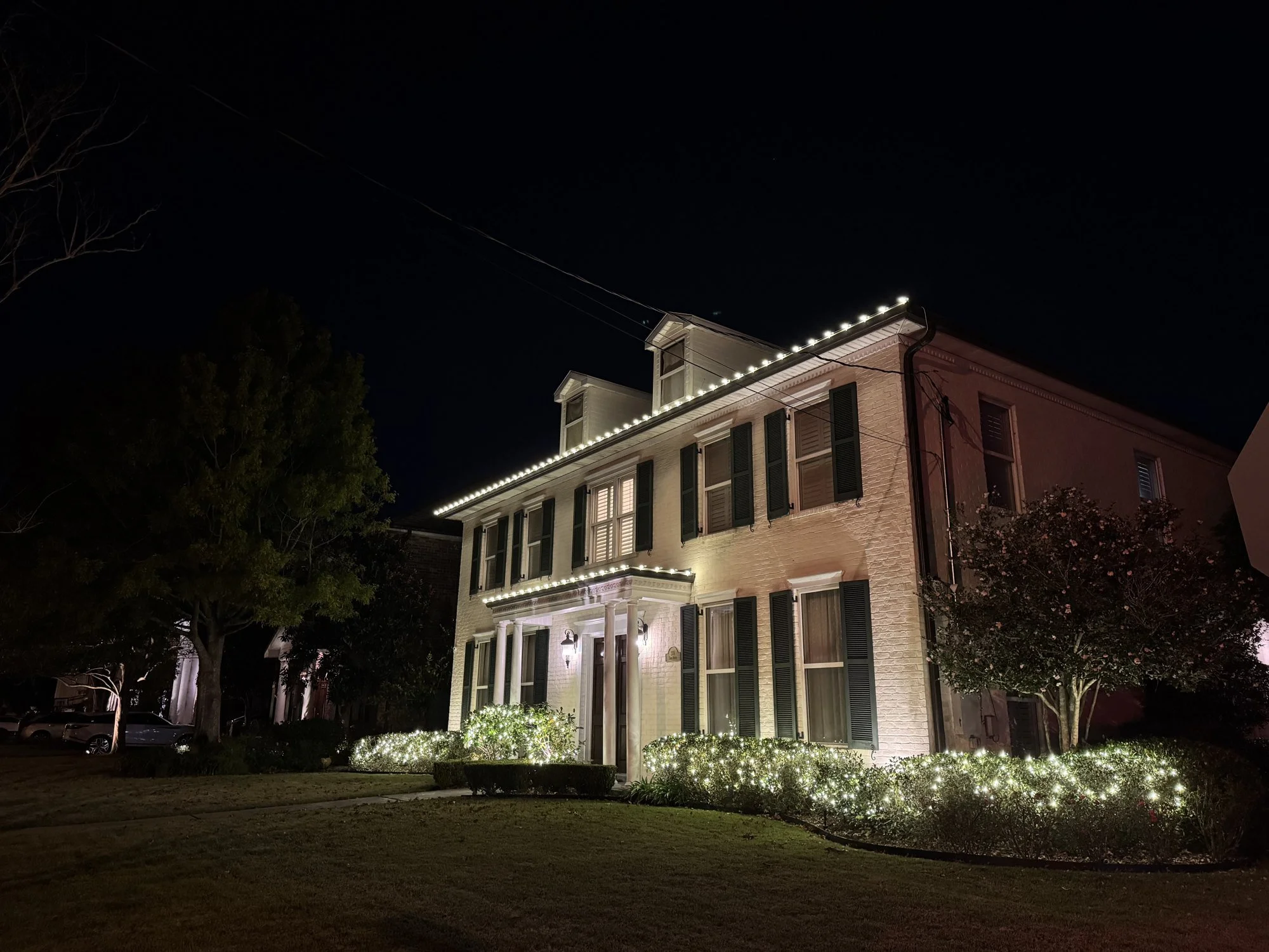 warm-white-christmas-lights-two-story-brick-house.jpg