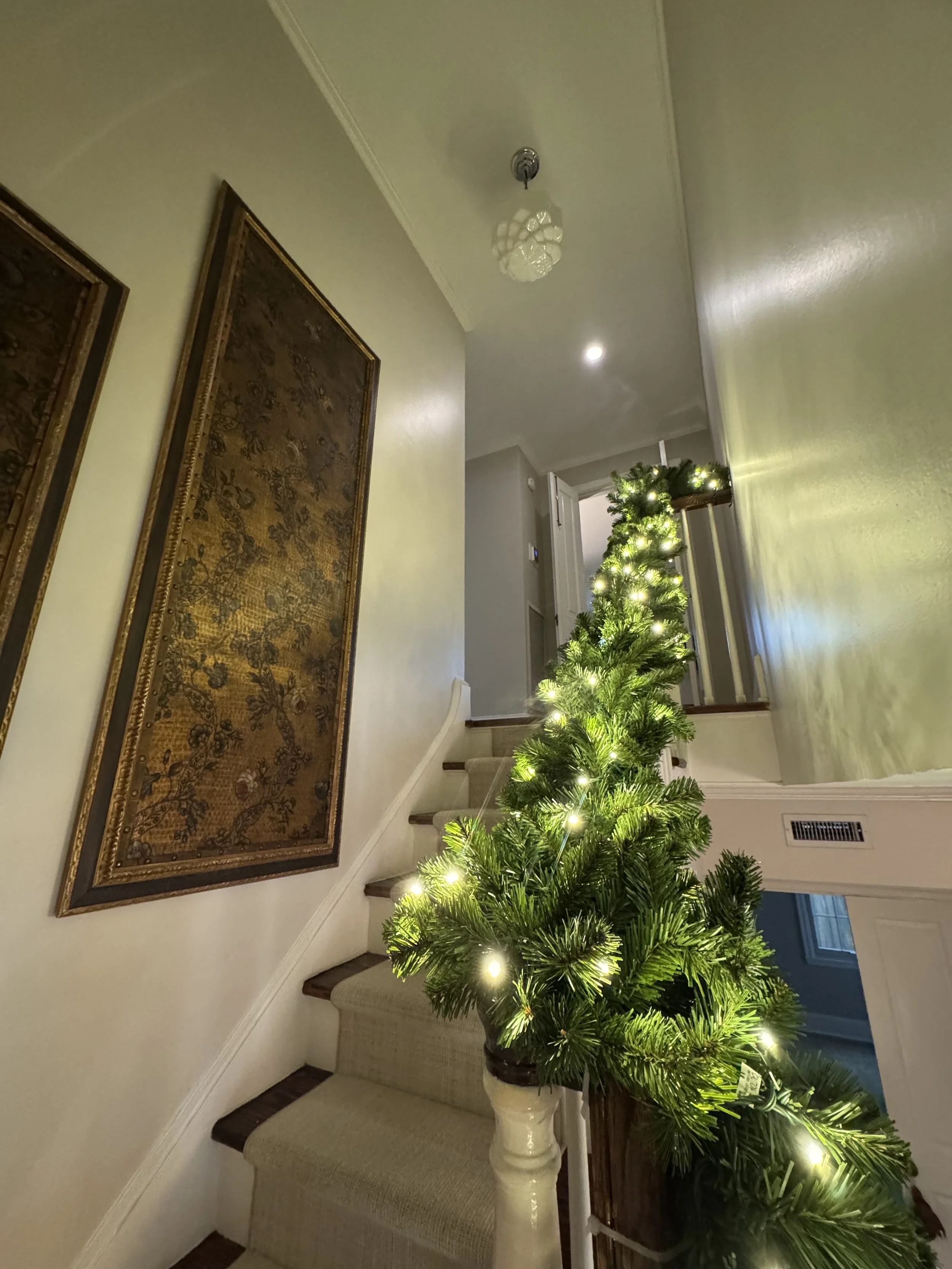 lit-garland-wrapped-staircase-banister.jpg