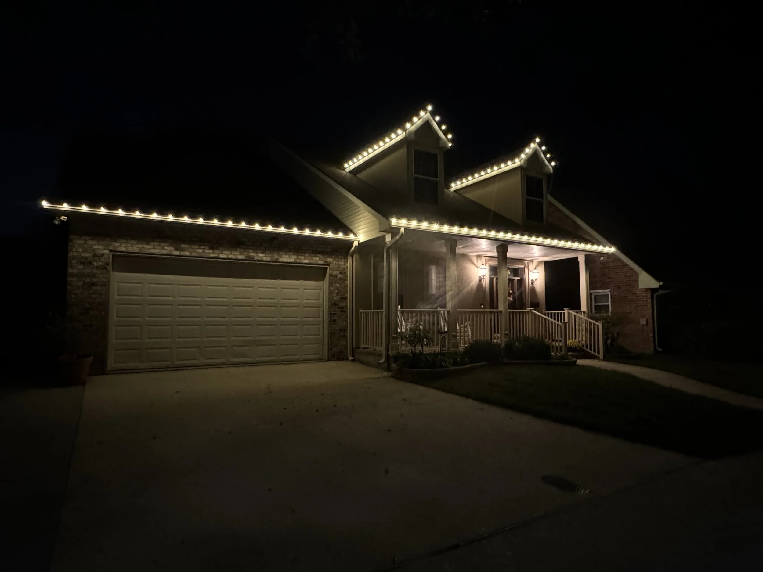 warm-white-christmas-lights-house-dormers-porch.jpg