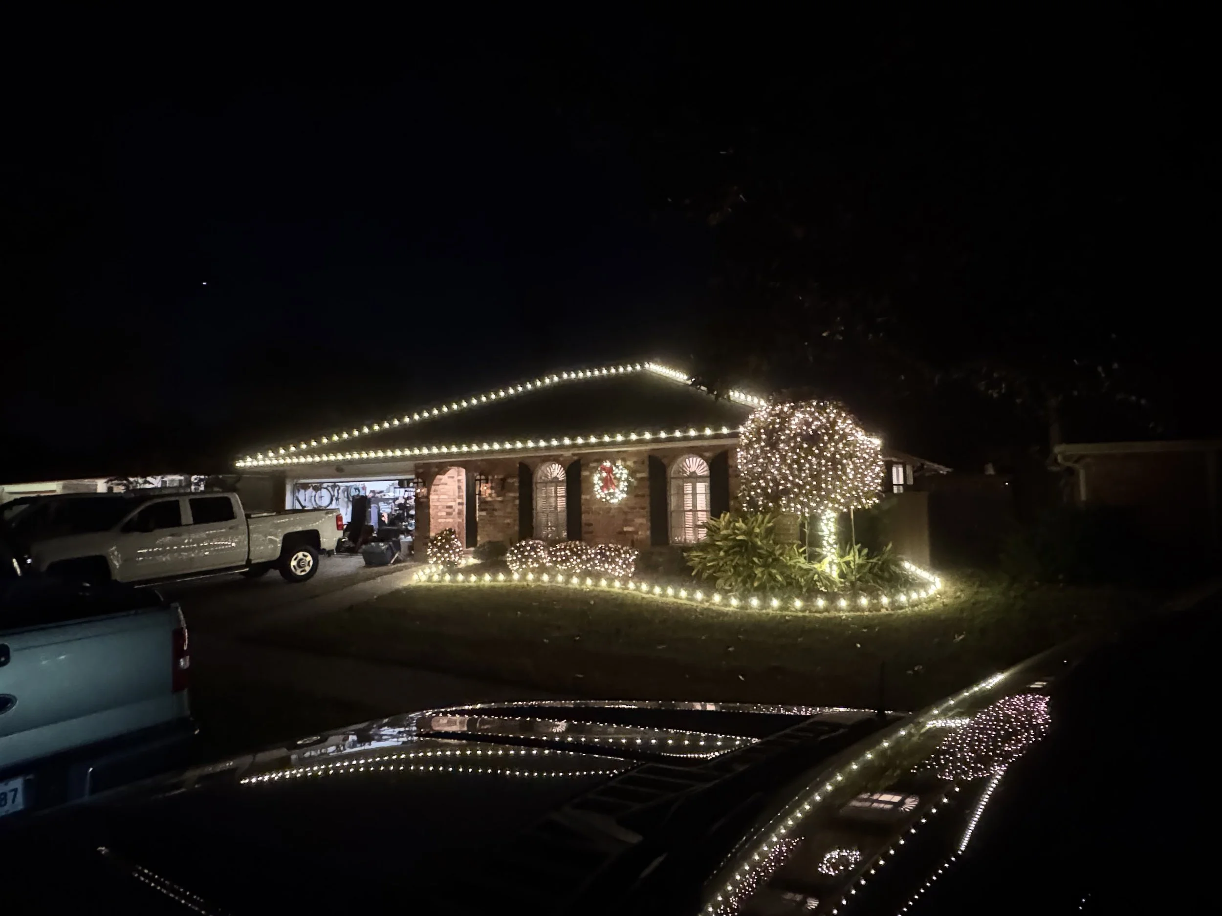 warm-white-christmas-lights-brick-house-tree-border.jpg