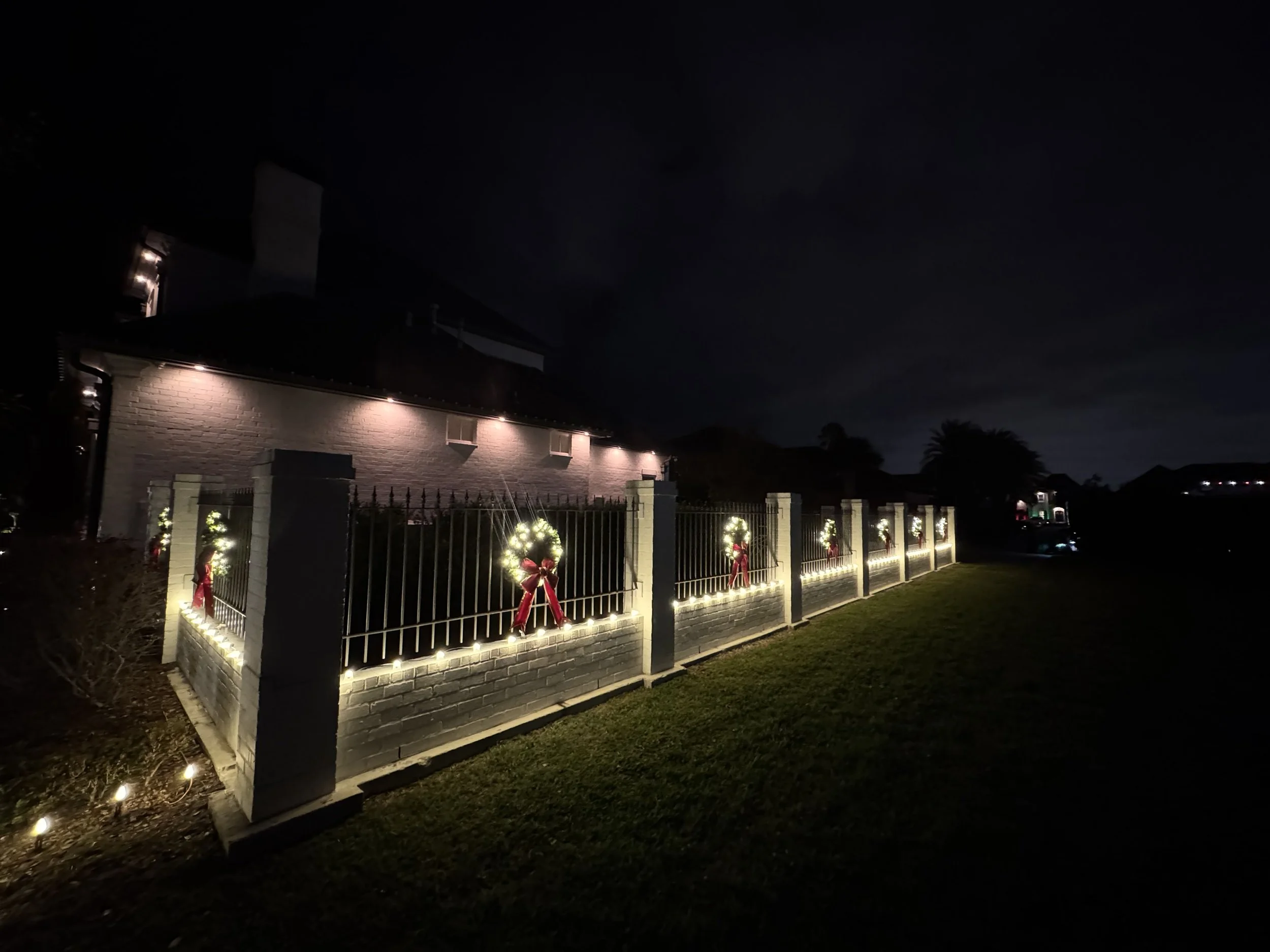 warm-white-lights-iron-fence-wreaths-side-view.jpg