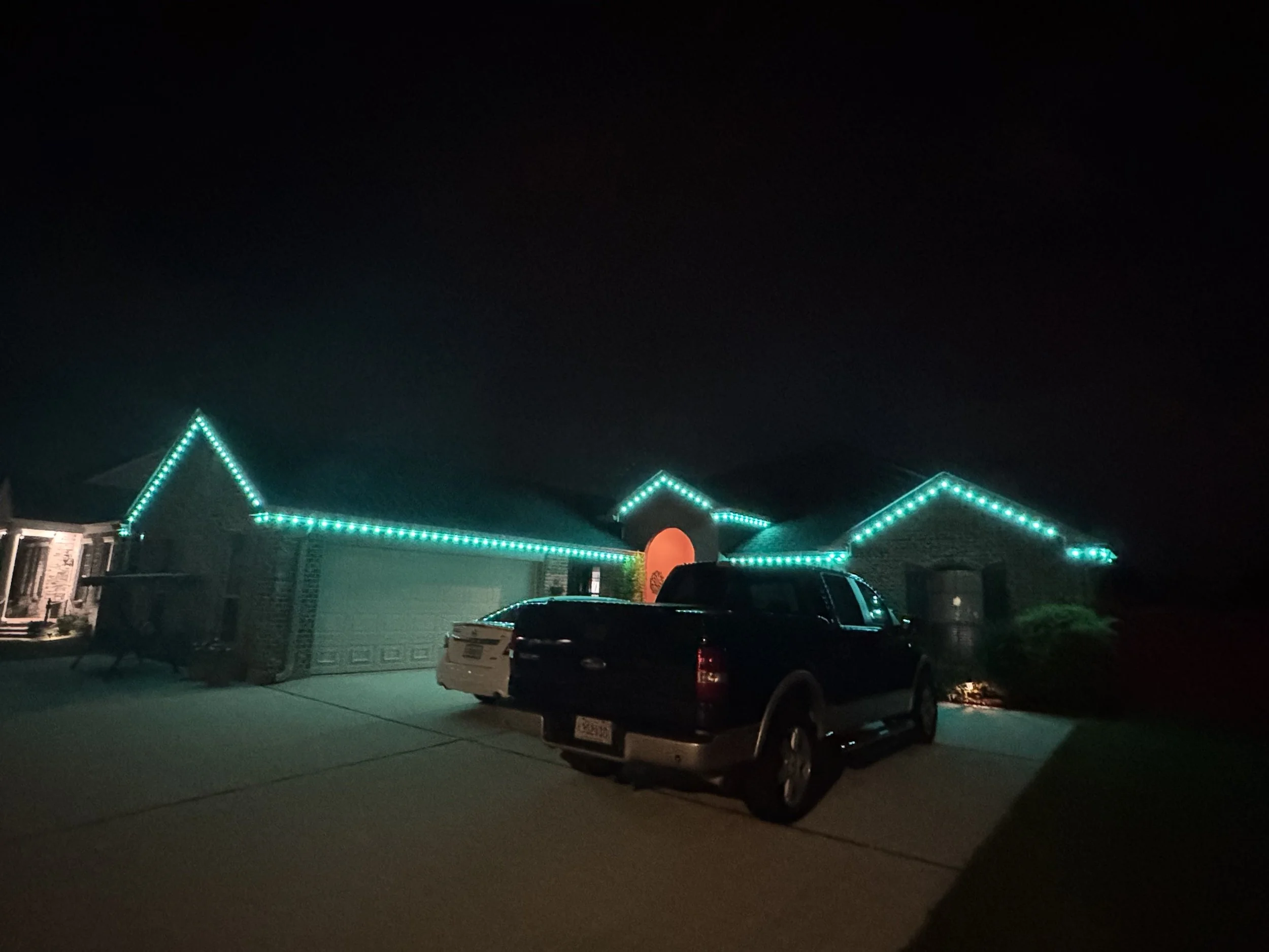 teal-permanent-lights-brick-home-roofline.jpg