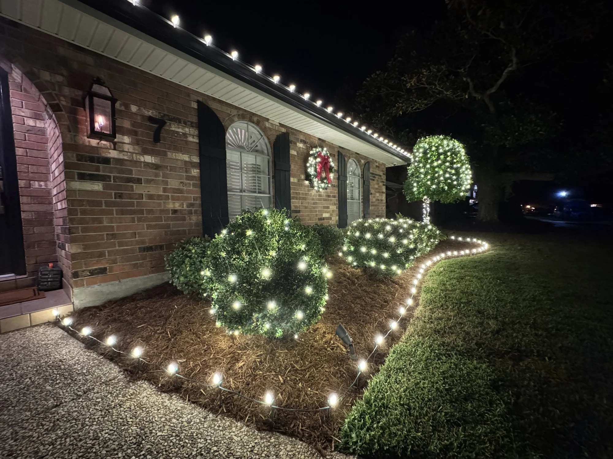 white-christmas-lights-shrubs-and-flowerbed.jpg