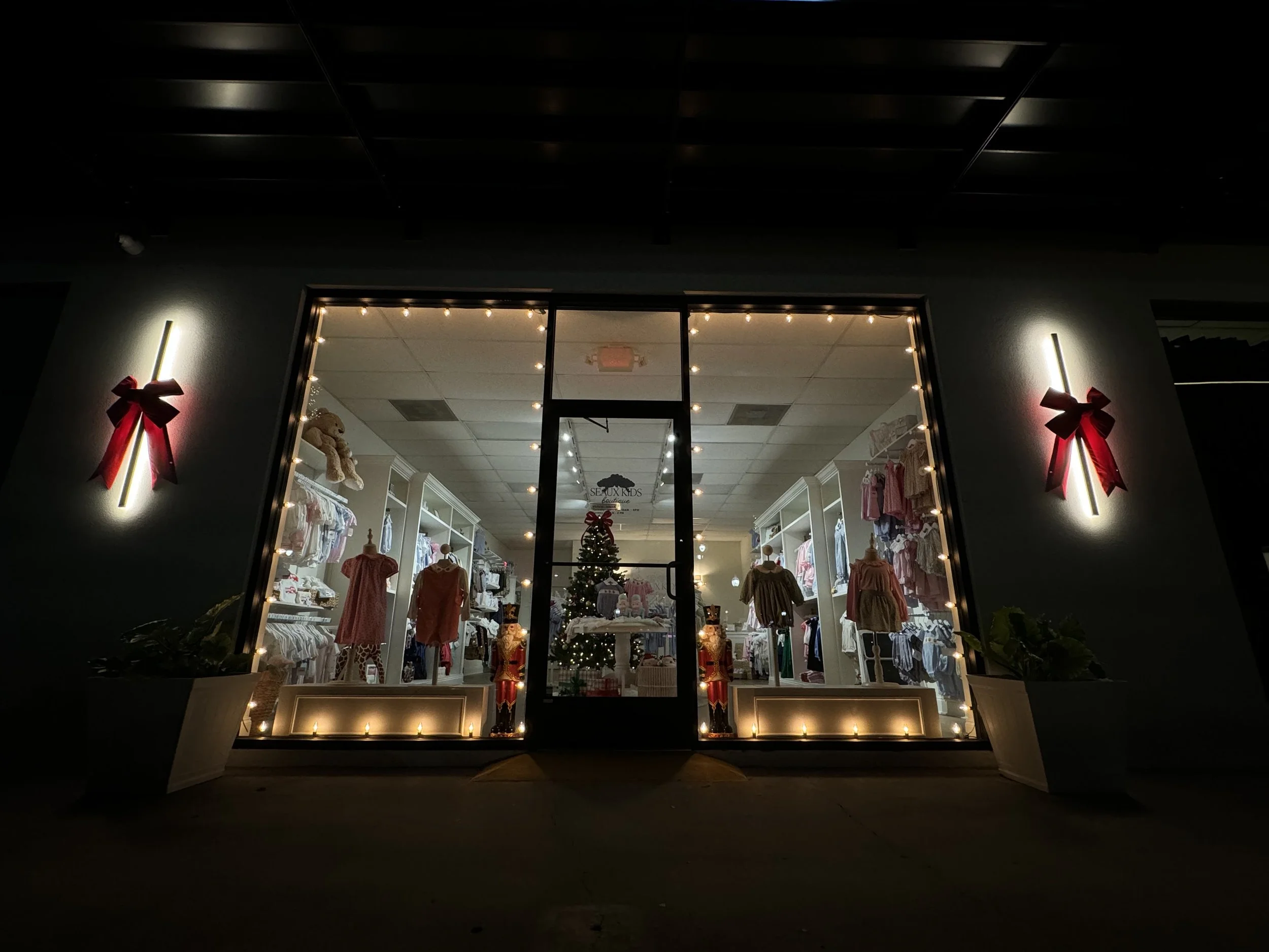 warm-white-lights-storefront-red-bows.jpg
