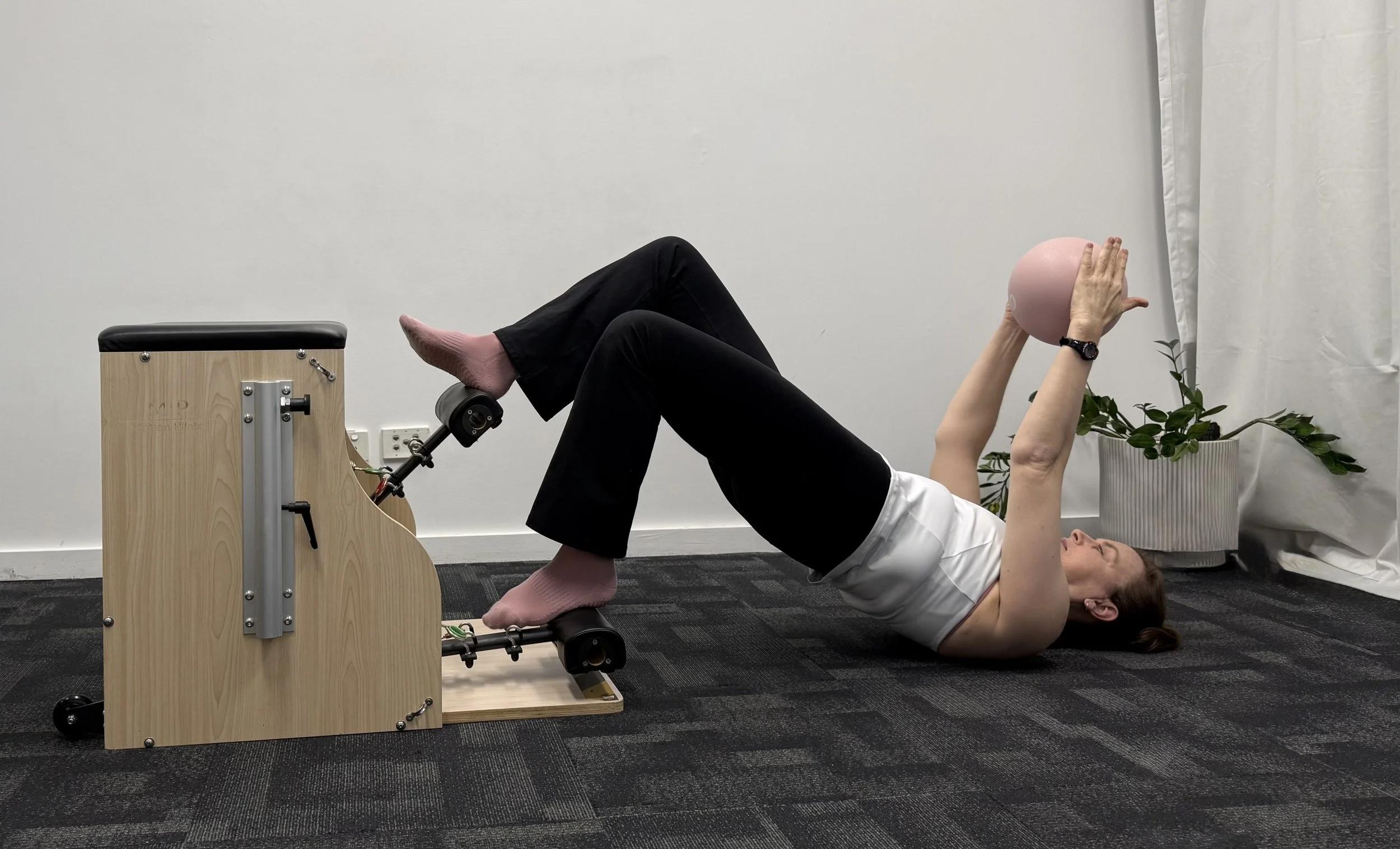 Woman performing Reformer Pilates exercise during teacher training in Penrith, Western Sydney