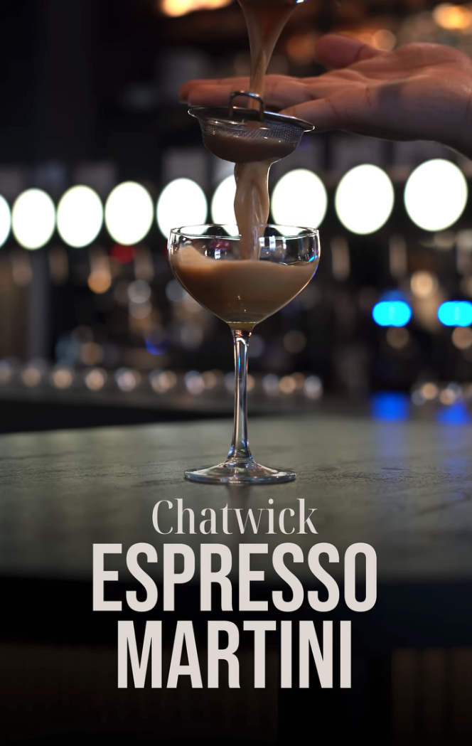 A bartender pours a creamy espresso martini through a metal strainer into a coupe glass. The background features bright circular lights and bar equipment. Text on the image reads "Chatwick Espresso Martini."