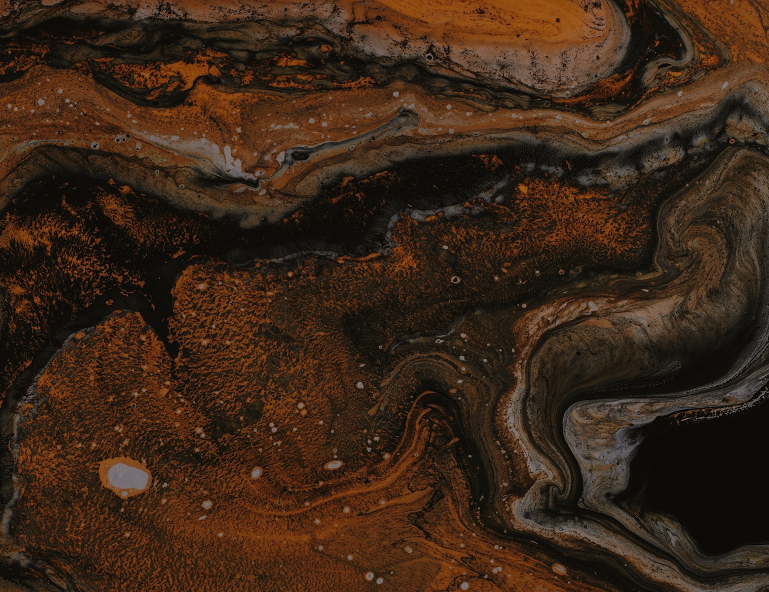 A swirling abstract pattern with orange, black, gray, and white colors creating a marbled effect.