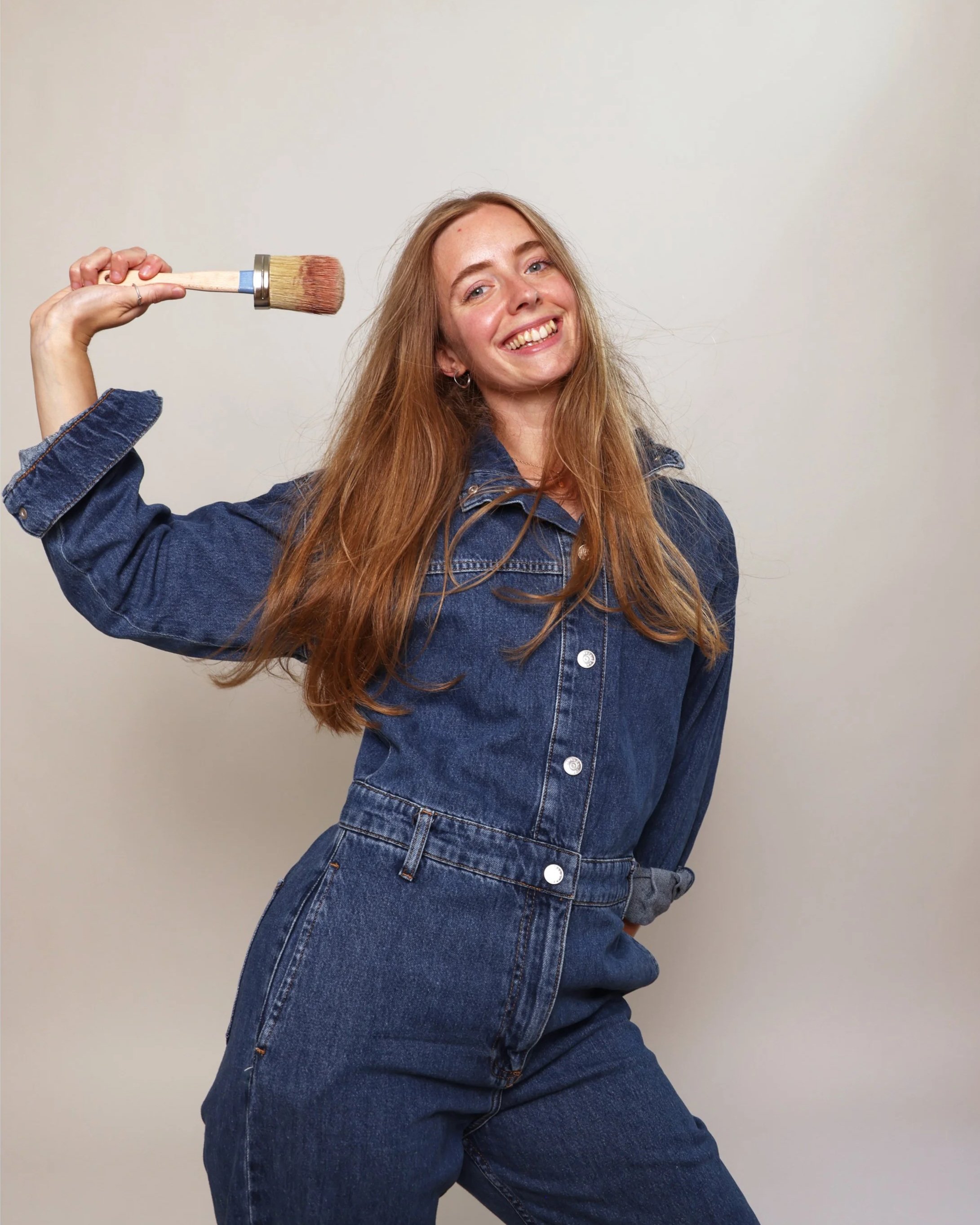 Victoria Sutton portrait holding a paint brush