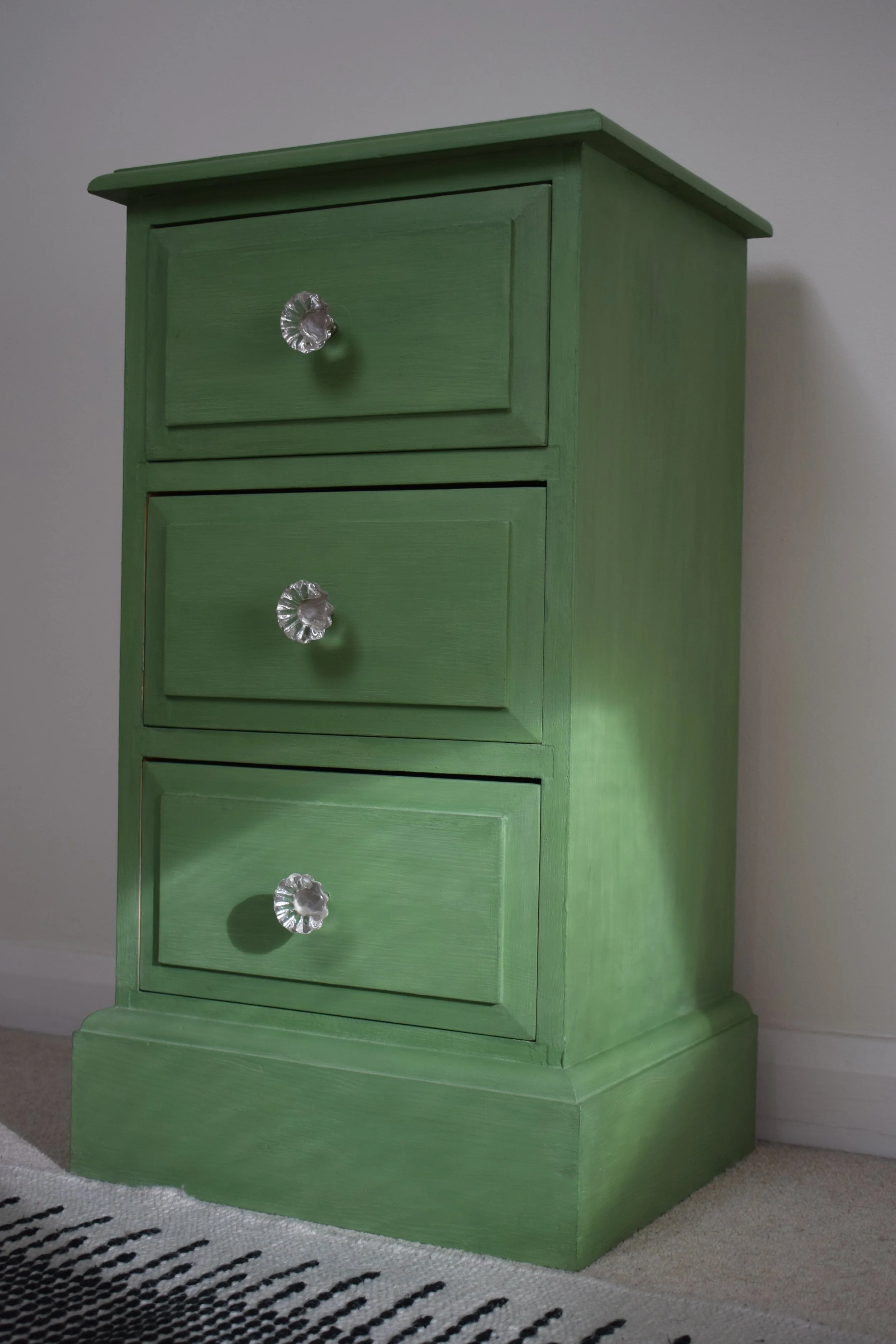 Small green painted chest of drawers with glass knobs