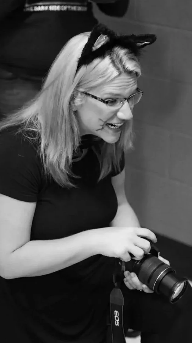 Stephanie Towne casually taking photos at an event.