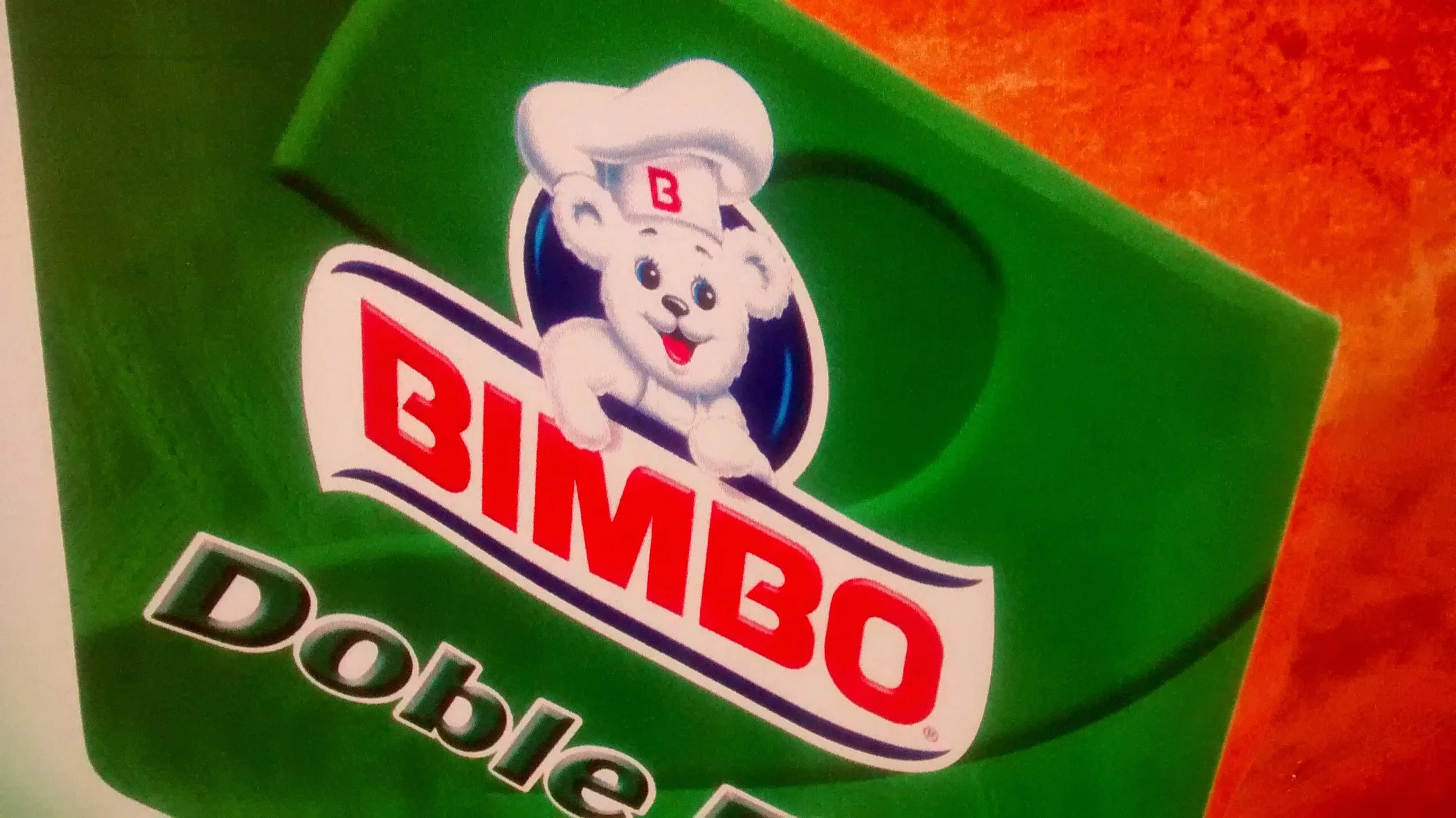 Close-up of a green Bimbo bread package featuring a cartoon white bear with blue eyes and a chef's hat.