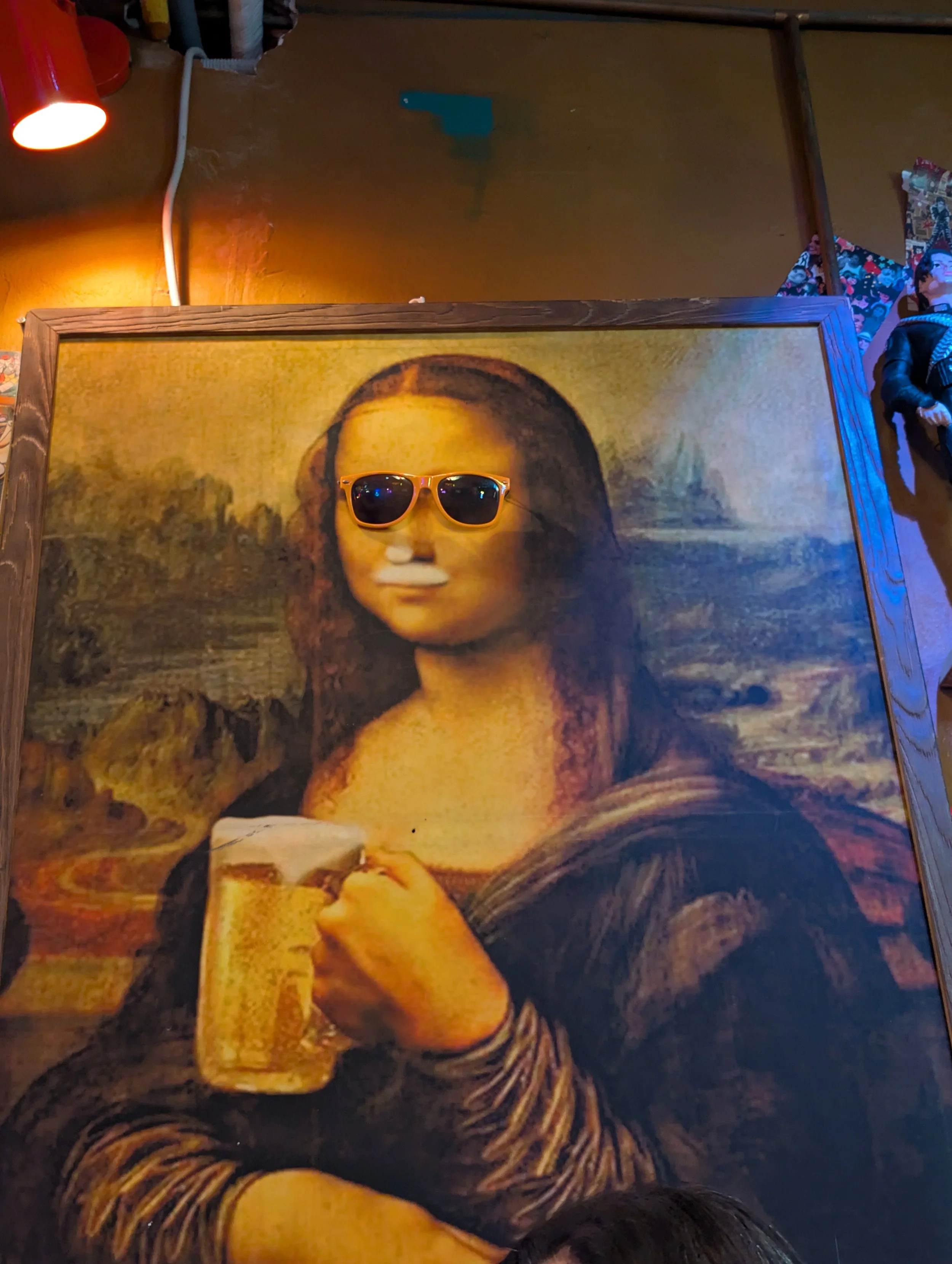 A painting of the Mona Lisa with a pair of sunglasses placed on it.