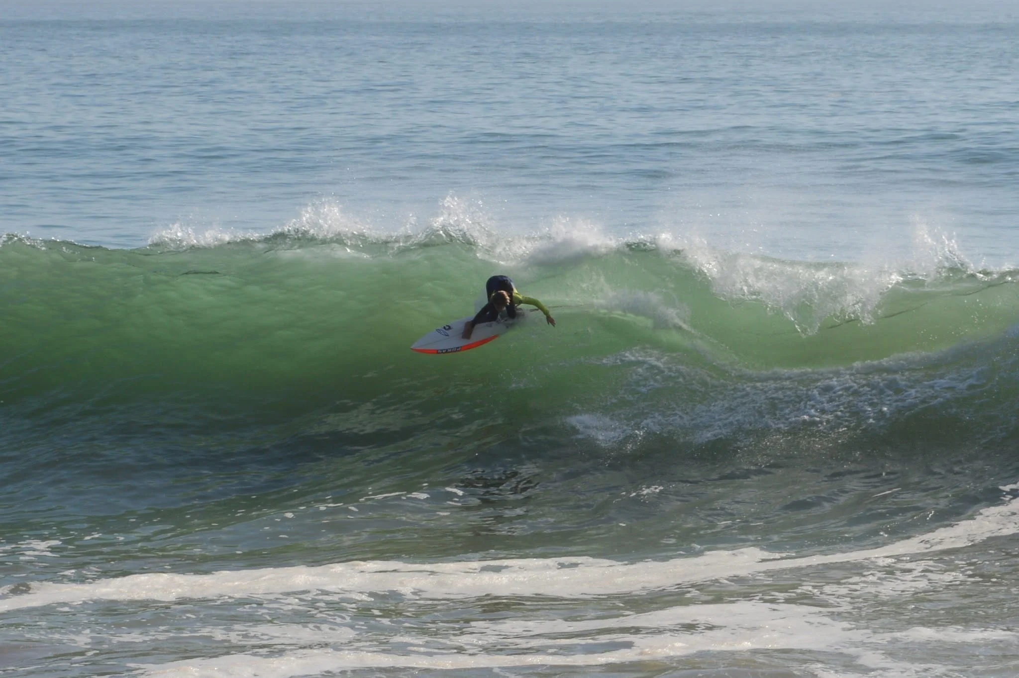 A person surfing on a wave in the ocean.