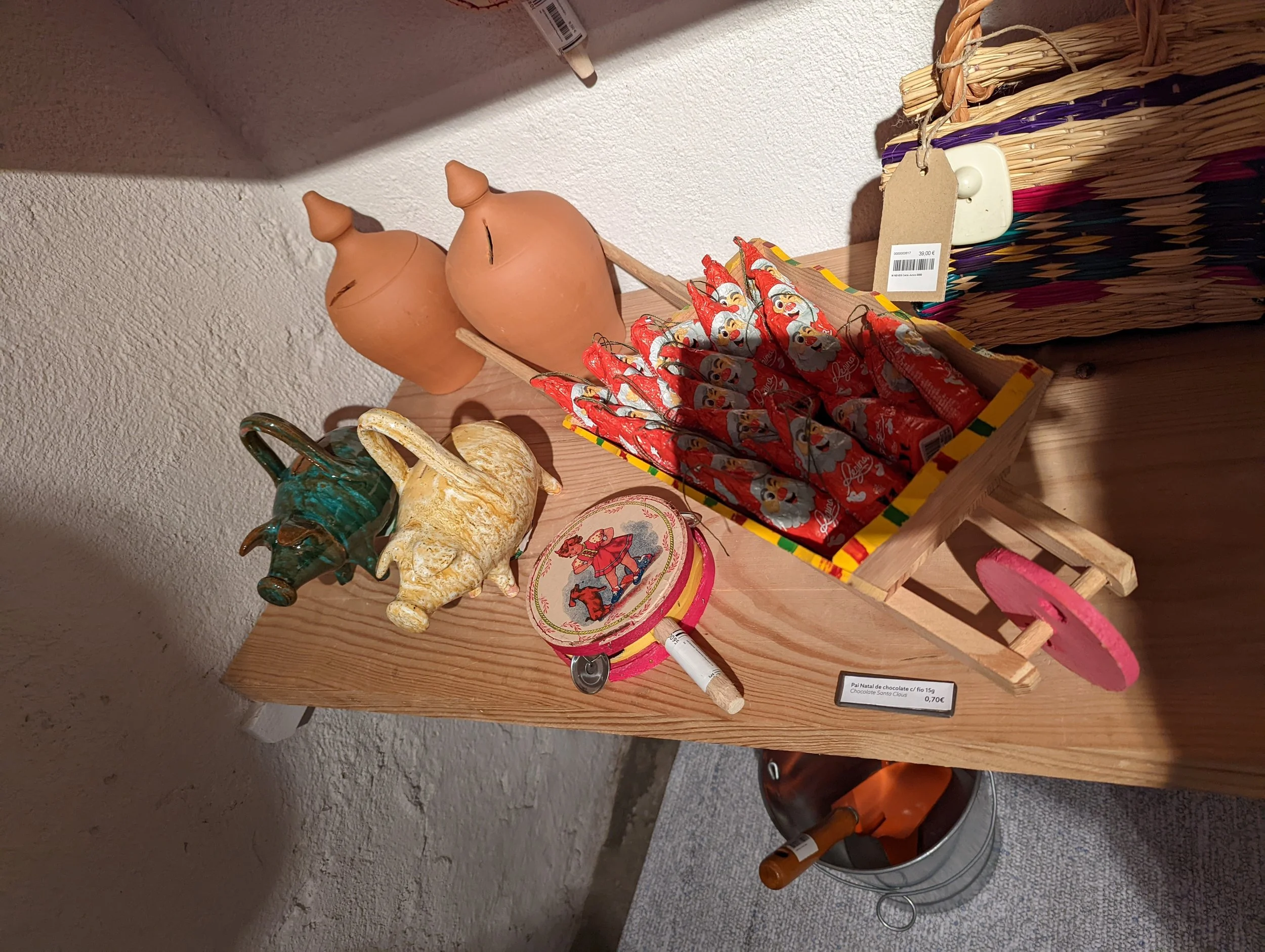Two terracotta pig-shaped money boxes on a wooden surface