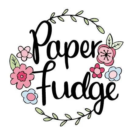 Illustration with the words "Paper Fudge" adorned with pink, blue, and red flowers and green leaves, surrounded by a leafy border.
