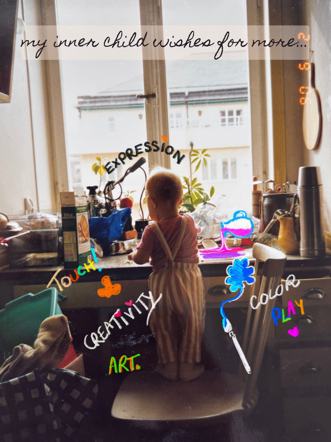 Child standing on a chair at a cluttered kitchen window sill, looking outside. The photo has colorful handwritten words and drawings including "my inner child wishes for more," "EXPESSION," "Touch!," "CREATIVITY," "ART," "COLOR," and "PLAY."