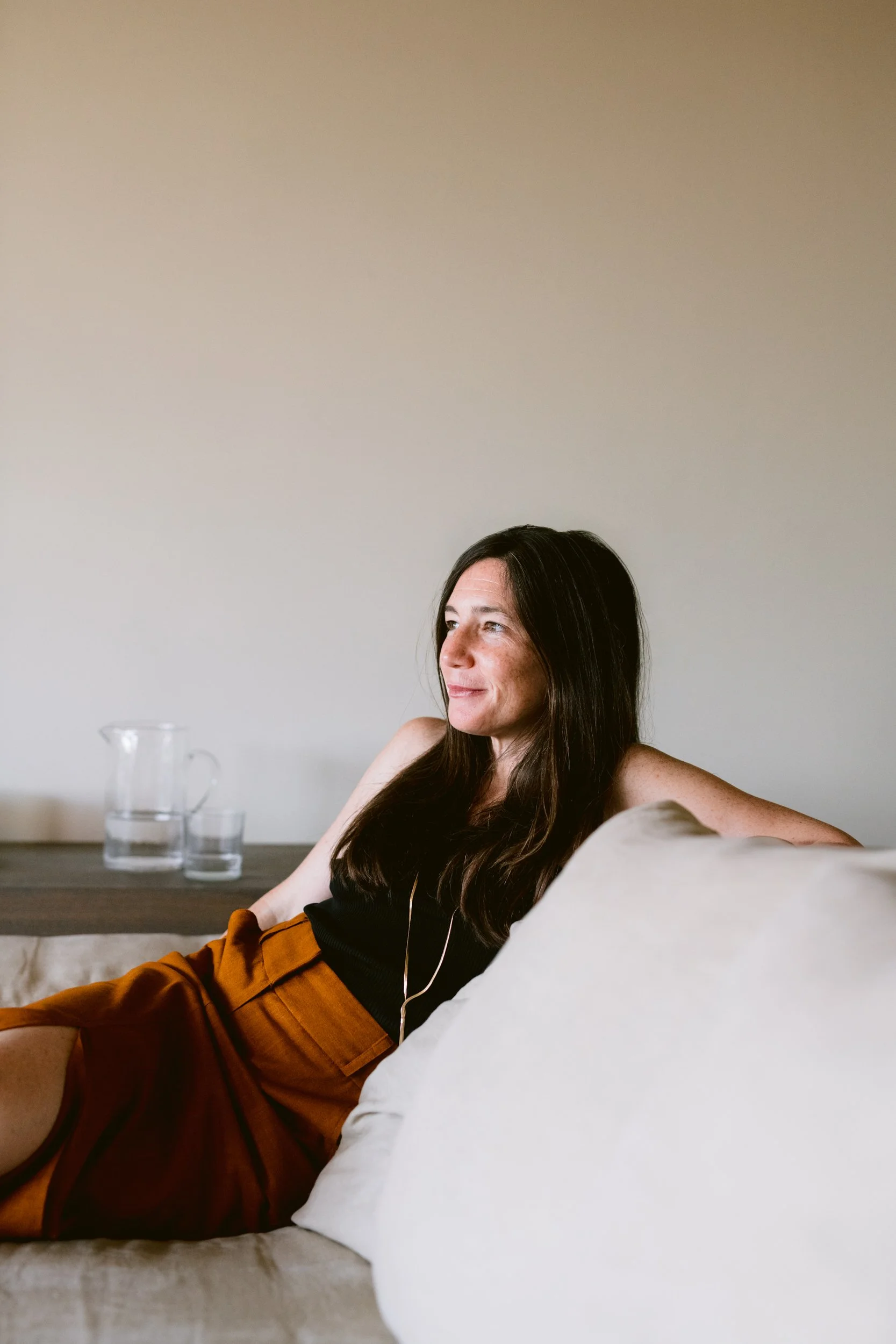 Ana Estrada, female leadership speaker and founder of Majesta, in a relaxed portrait at home.
