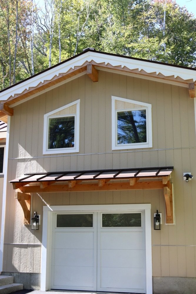 Home addition with wood siding and a new attached garage