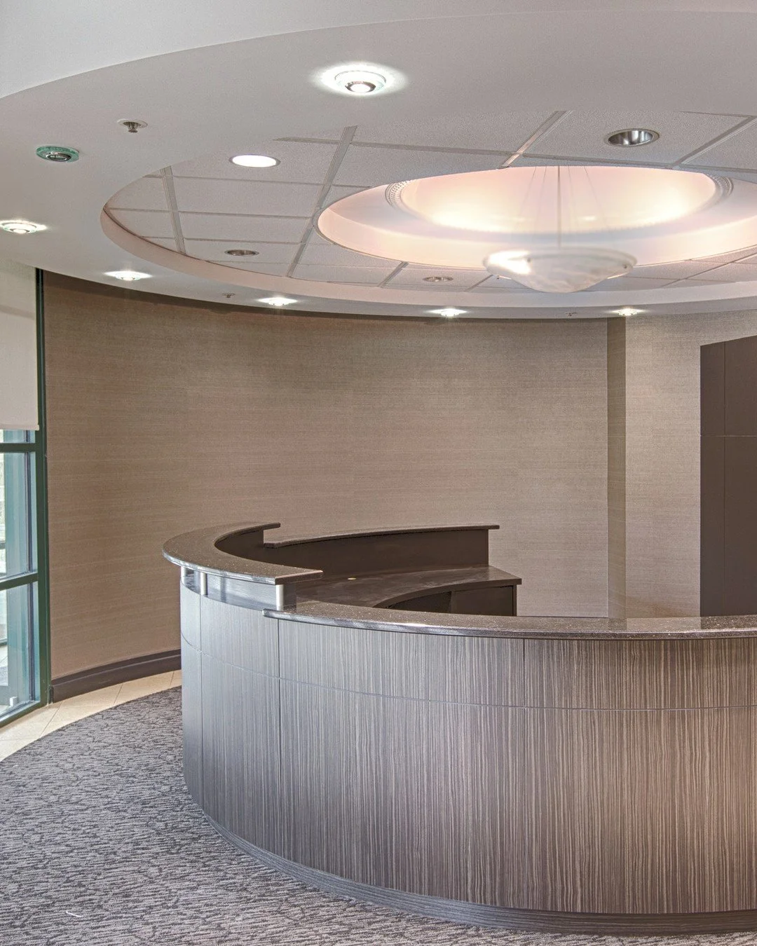 This reception desk was refinished in two 3M DI-NOC wood films, a metallic wood and a fine wood grain. DI-NOC architectural film is applied over the existing surfaces, so the desk stays where it is and takes on an entirely new finish.

See DI-NOC fin
