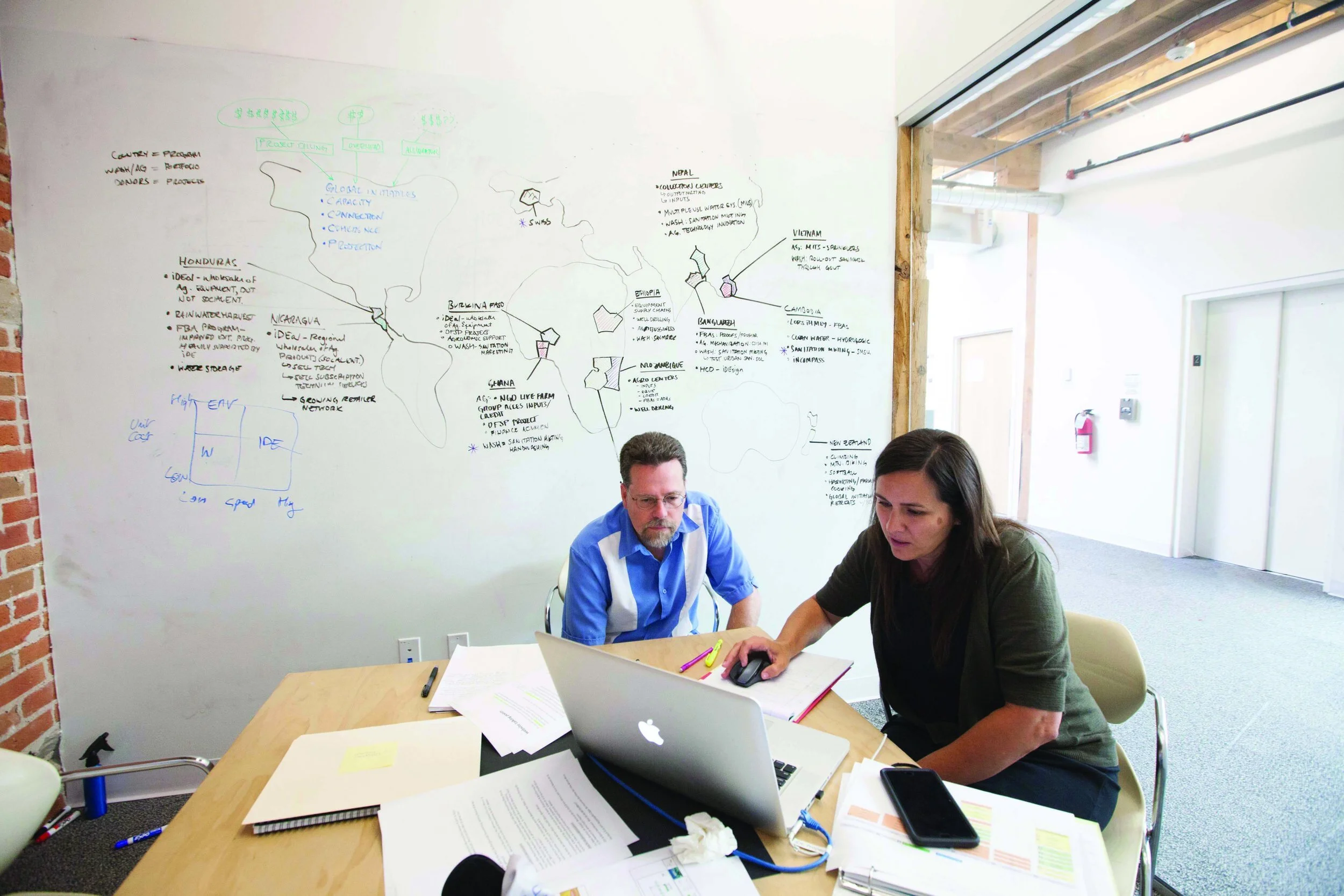 Here, staff at anchor tenant, iDE, hold a meeting in a Flex Room, where they’ve mapped out meeting notes on the whiteboard wall behind them.