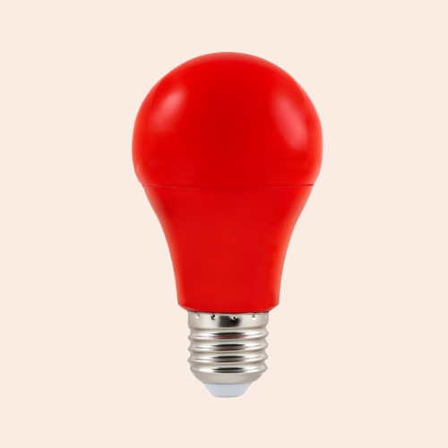 A red LED light bulb on a pink-ish background.