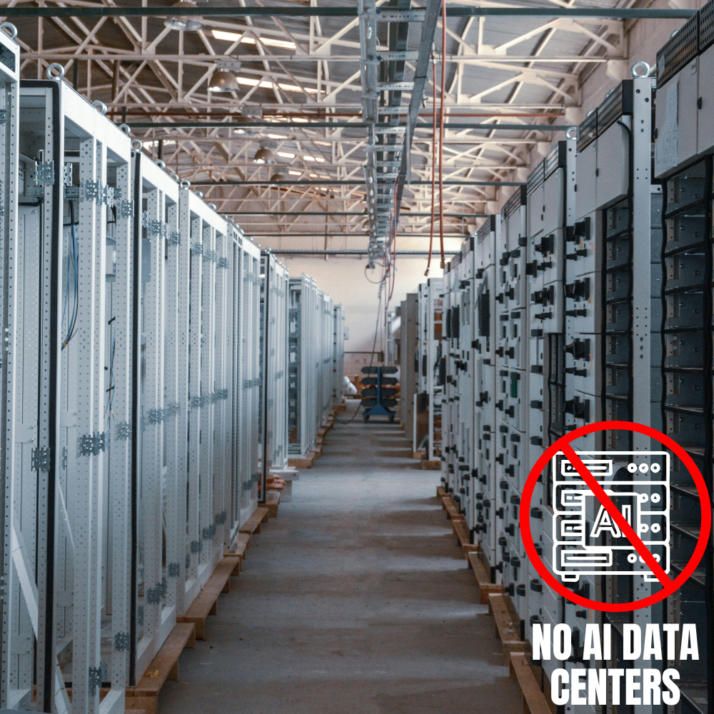 Server racks in a data center with a sign that has a red circle and slash over a server icon, and the text "NO AI DATA CENTERS".