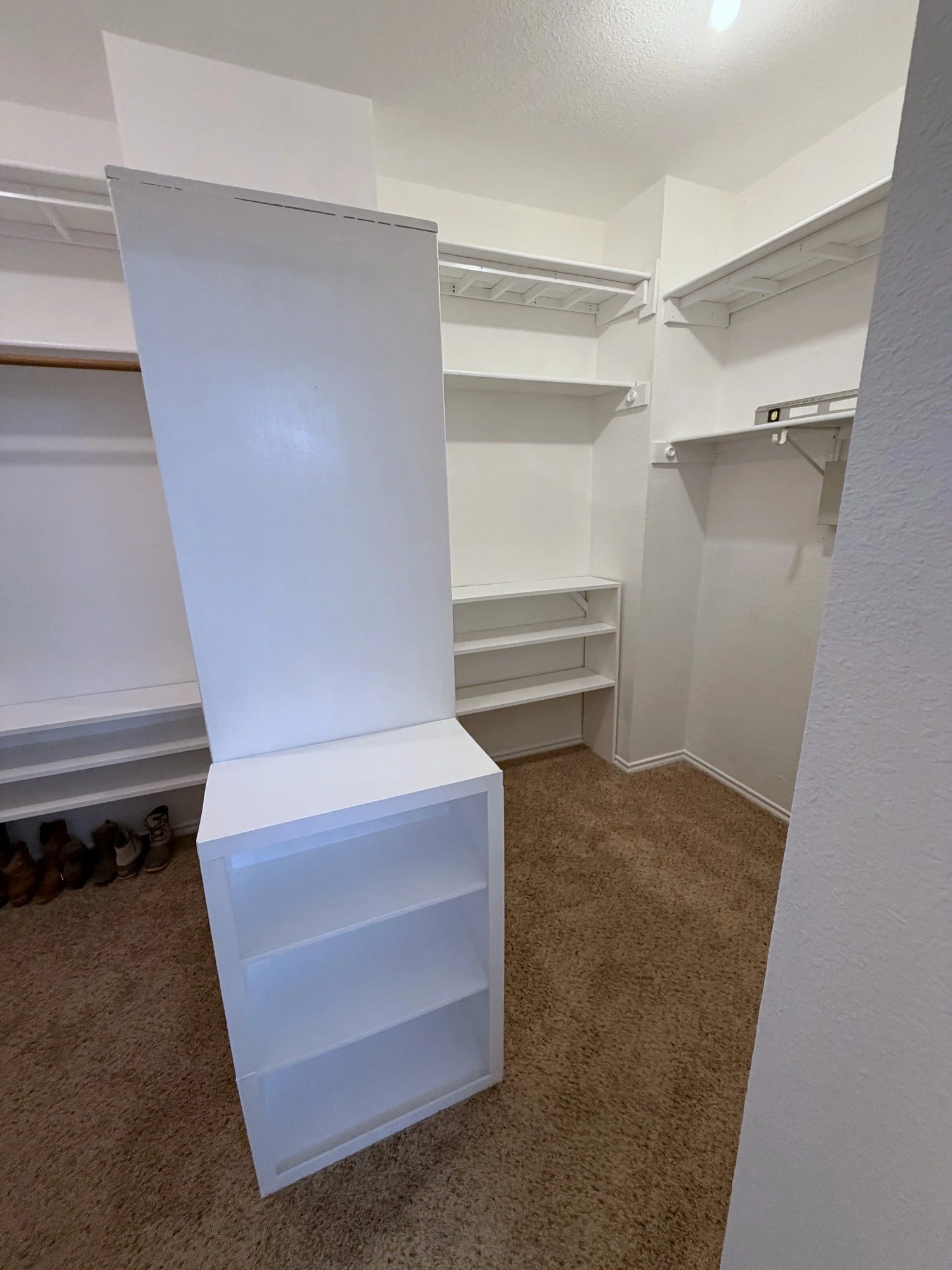 fresh white paint on new custom shelves in empty closet
