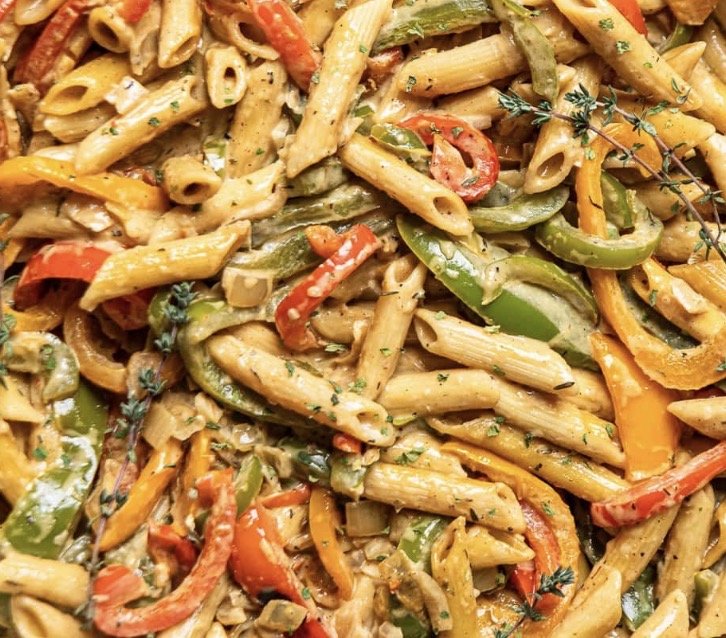 Mixed pasta salad with penne pasta, bell peppers, herbs, and seasonings.