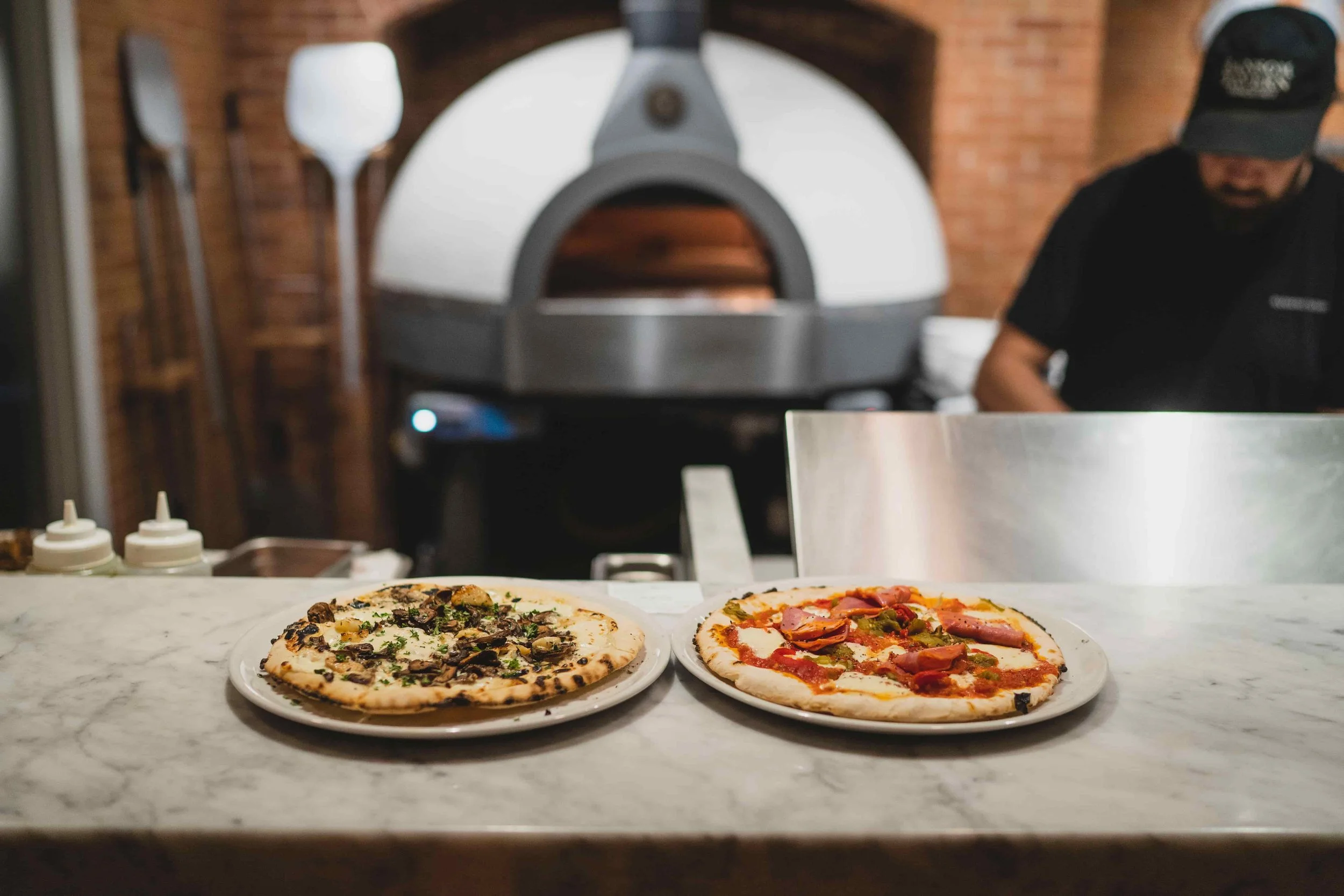 ransom-tavern-south-woodstock-vt-pizzas-plated-oven-employee.jpg