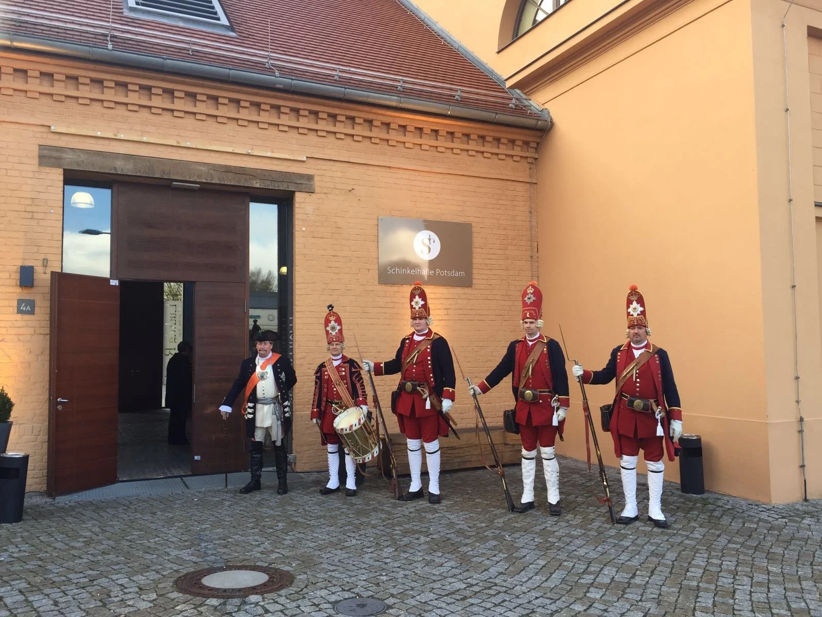 Traditionelle Gardisten in historischer Uniform vor dem Gebäude der Schinkelhallen in Potsdam.