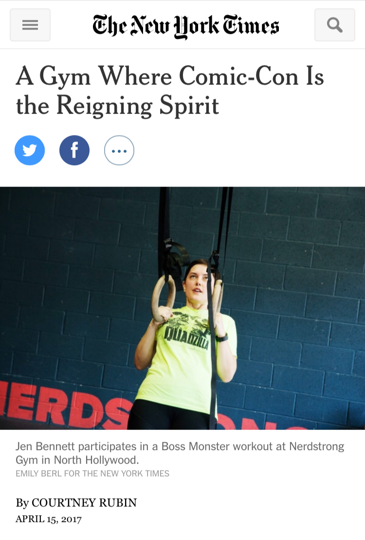 A screenshot of a New York Times article entitled, "A Gym Where Comic-Con is the Reigning Spirit". It shows a photograph of a female in a yellow shirt performing a ring row exercise.