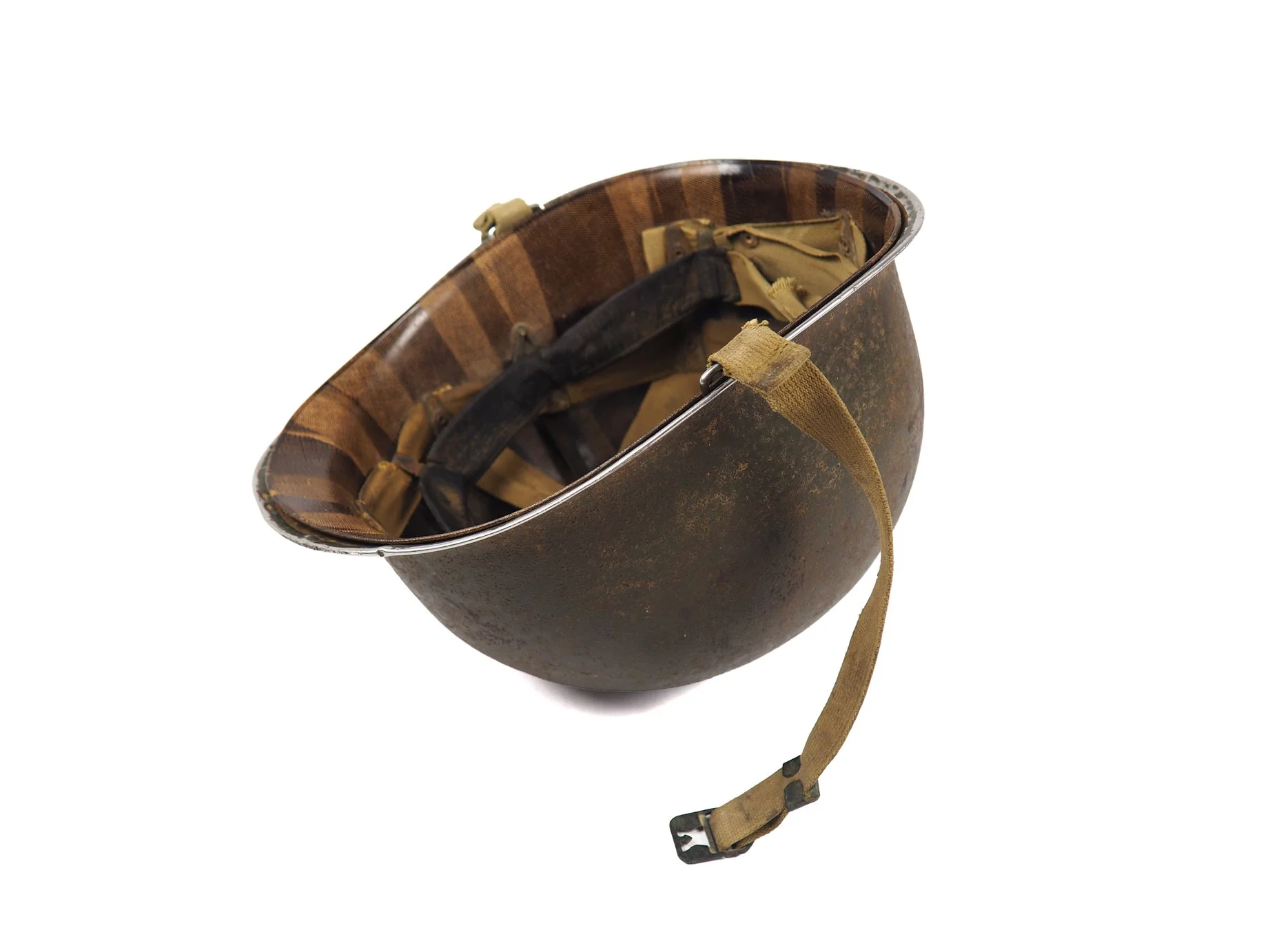 The interior of Tec/5 O'Rourke's helmet remains covered in dirt and grime, the history of its last 80 years of life remaining unknown until its discovery in 2023.