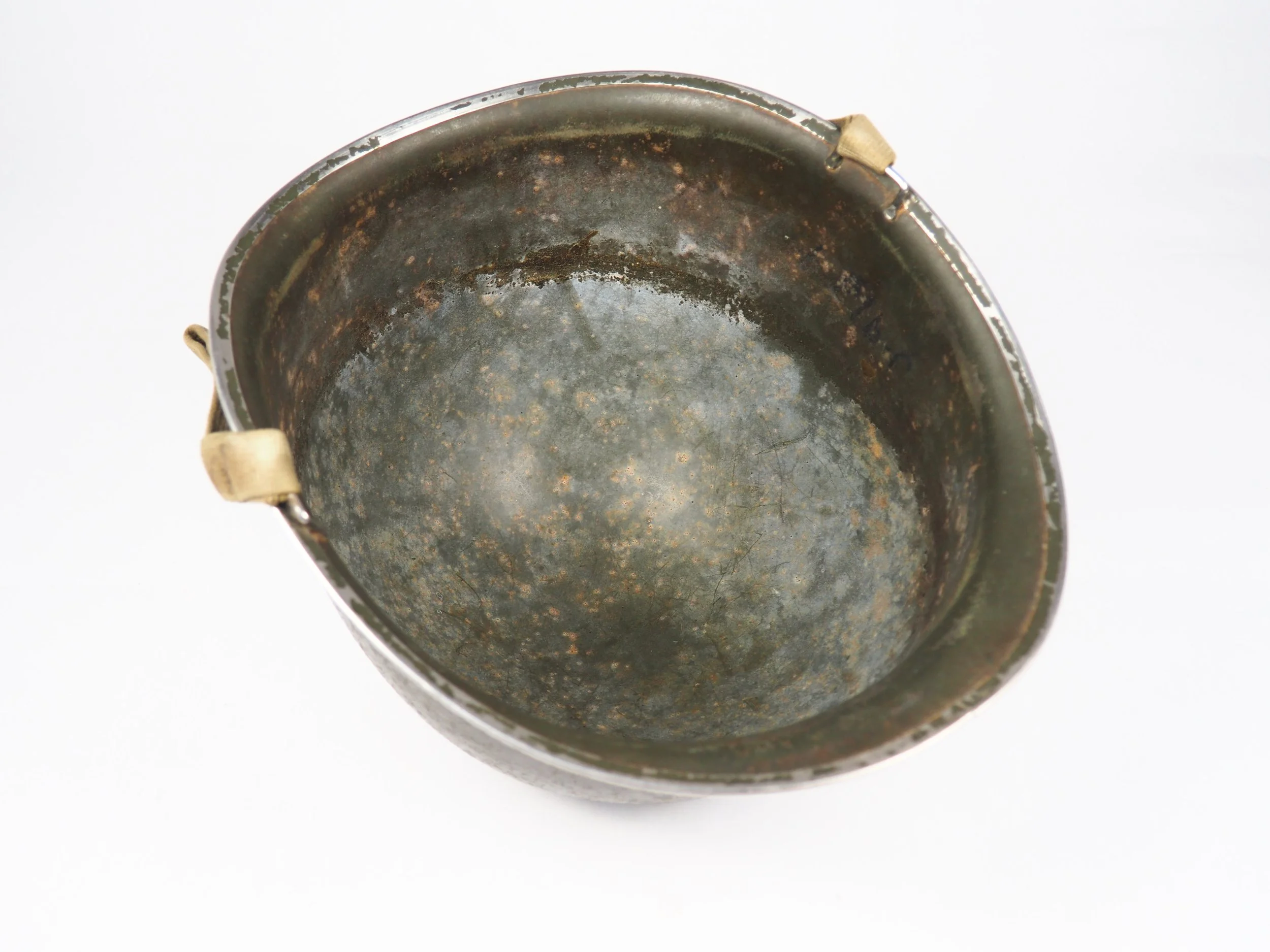Dense soap residue accumulated inside the helmet shell, as is typical for genuine and untouched combat used helmets.. 