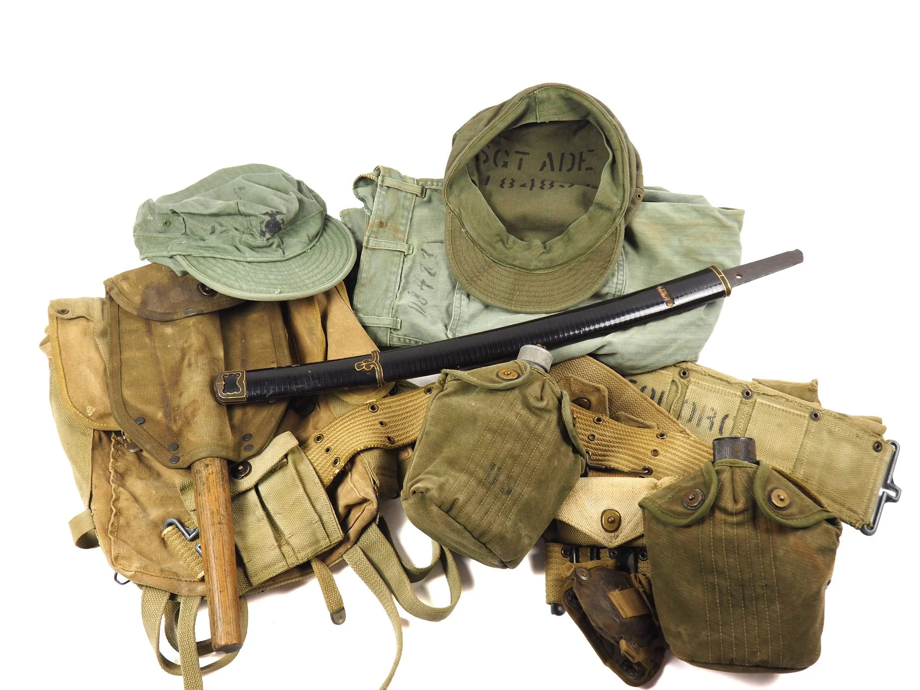 Multiple pieces of kit of Sgt. Ade's to include a Chinese sword. Also of note, he had an M1943 Entrenching tool that was shortened.
