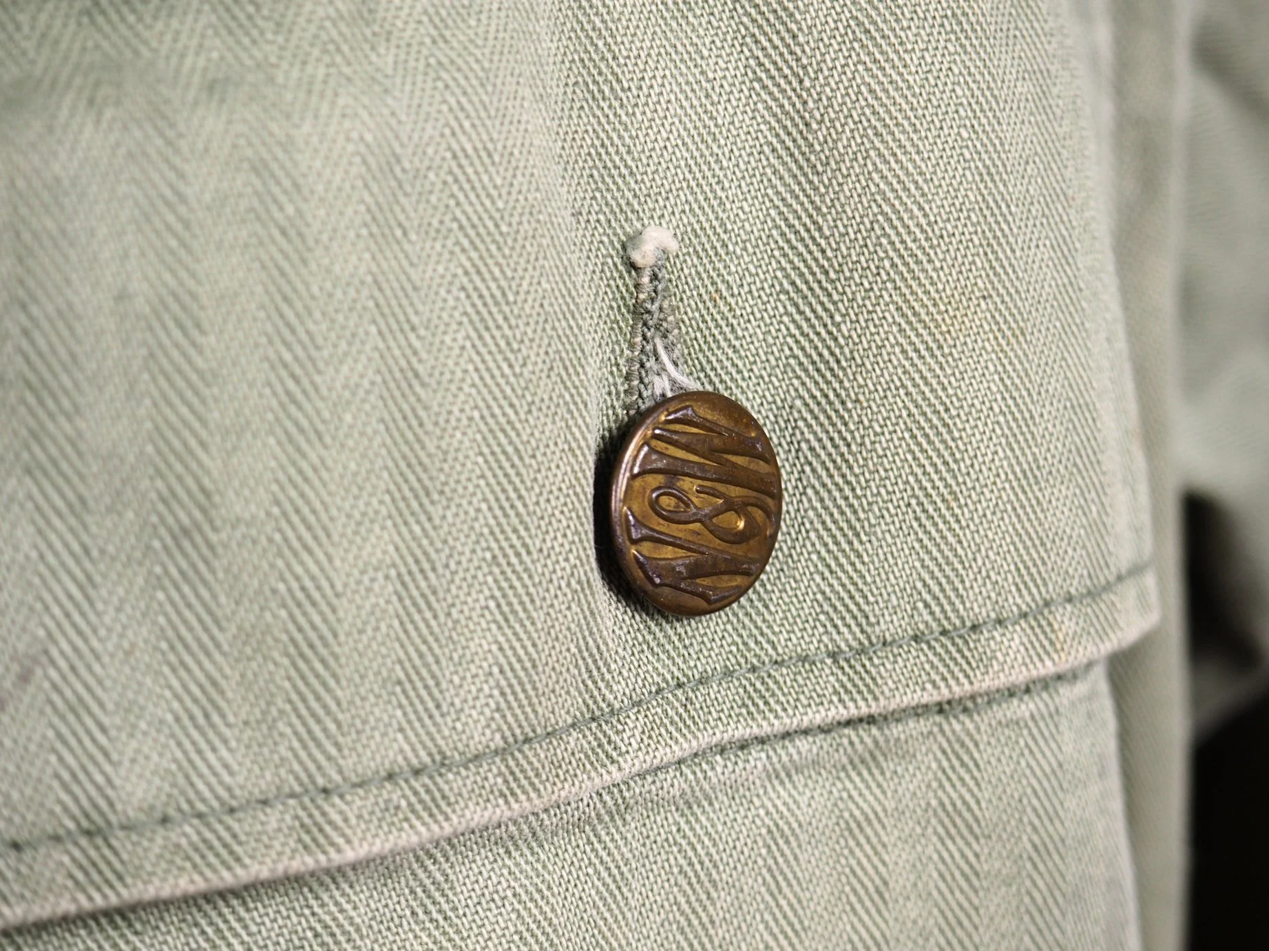 These buttons are from the Norfolk & Western Railroad and every button on the jacket was replaced with these. Perhaps they were mailed to him in Korea? Perhaps he utilized the jacket after the war as work wear?