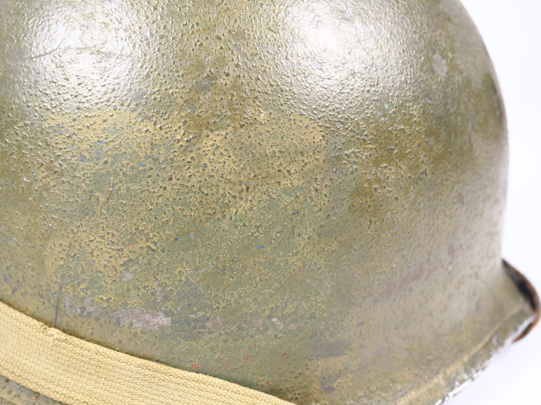 There is some sort of marking underneath the paint on this helmet. It resembles 3rd Infantry Division insignia, but the meaning is unknown. 