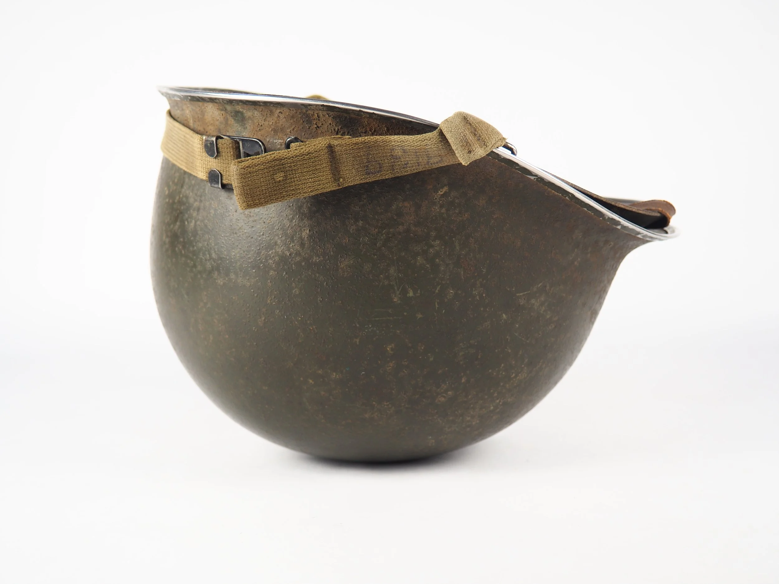 The grime from combat can be seen all over this helmet, especially the buildup underneath the chinstraps.
