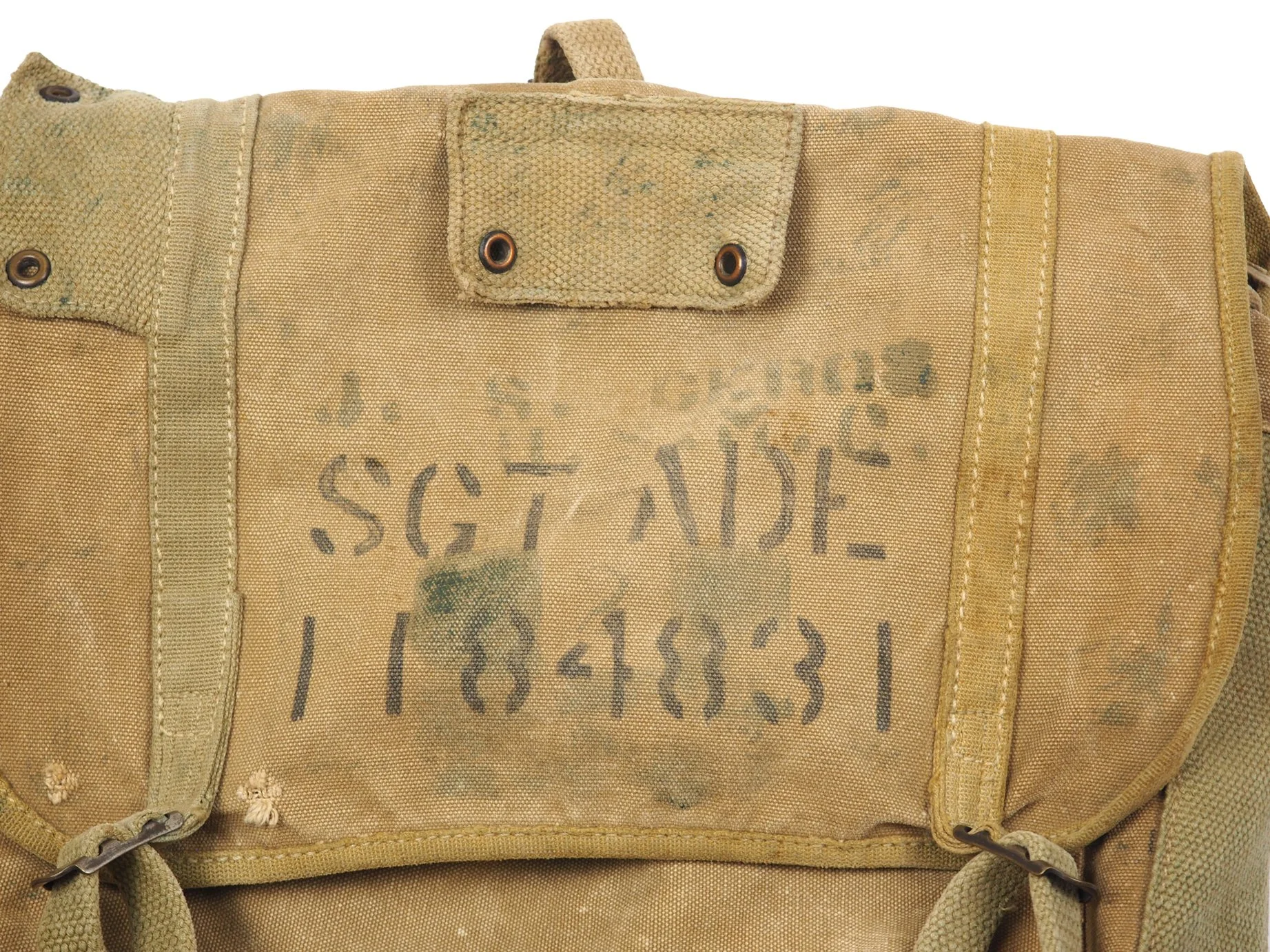 Closer examination reveals this haversack was once used by James S. Geros, 2nd Engineer Battalion, a veteran of Okinawa during World War II, where camouflage equipment was fairly common.