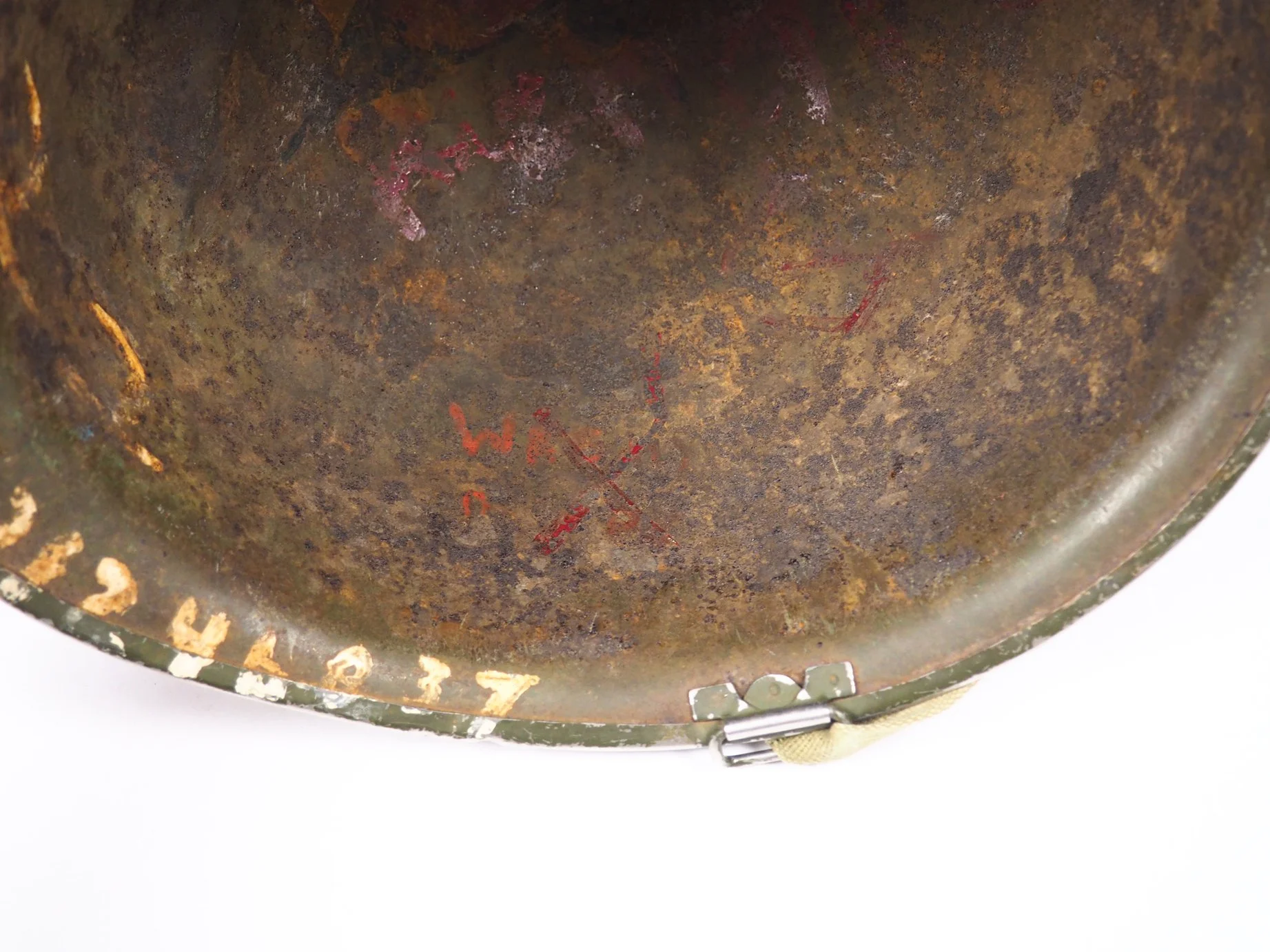The remnants of the former owners name and serial number that has been crossed out.
