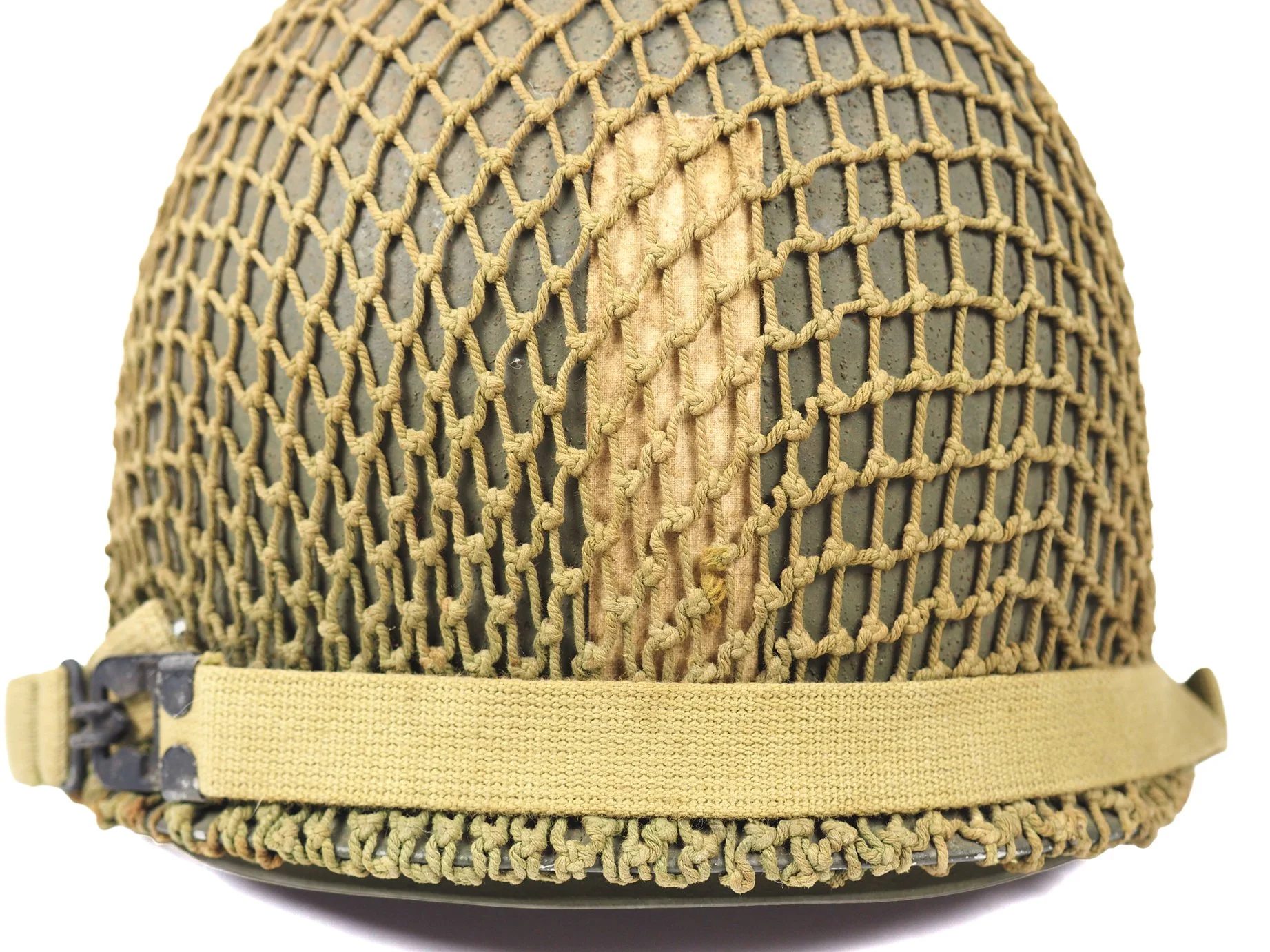 The "ETO Bar", or a vertical stripe used to identify officers in the field, applied with a strip of medical tape on the rear of Lieutenant Hamisch's helmet.