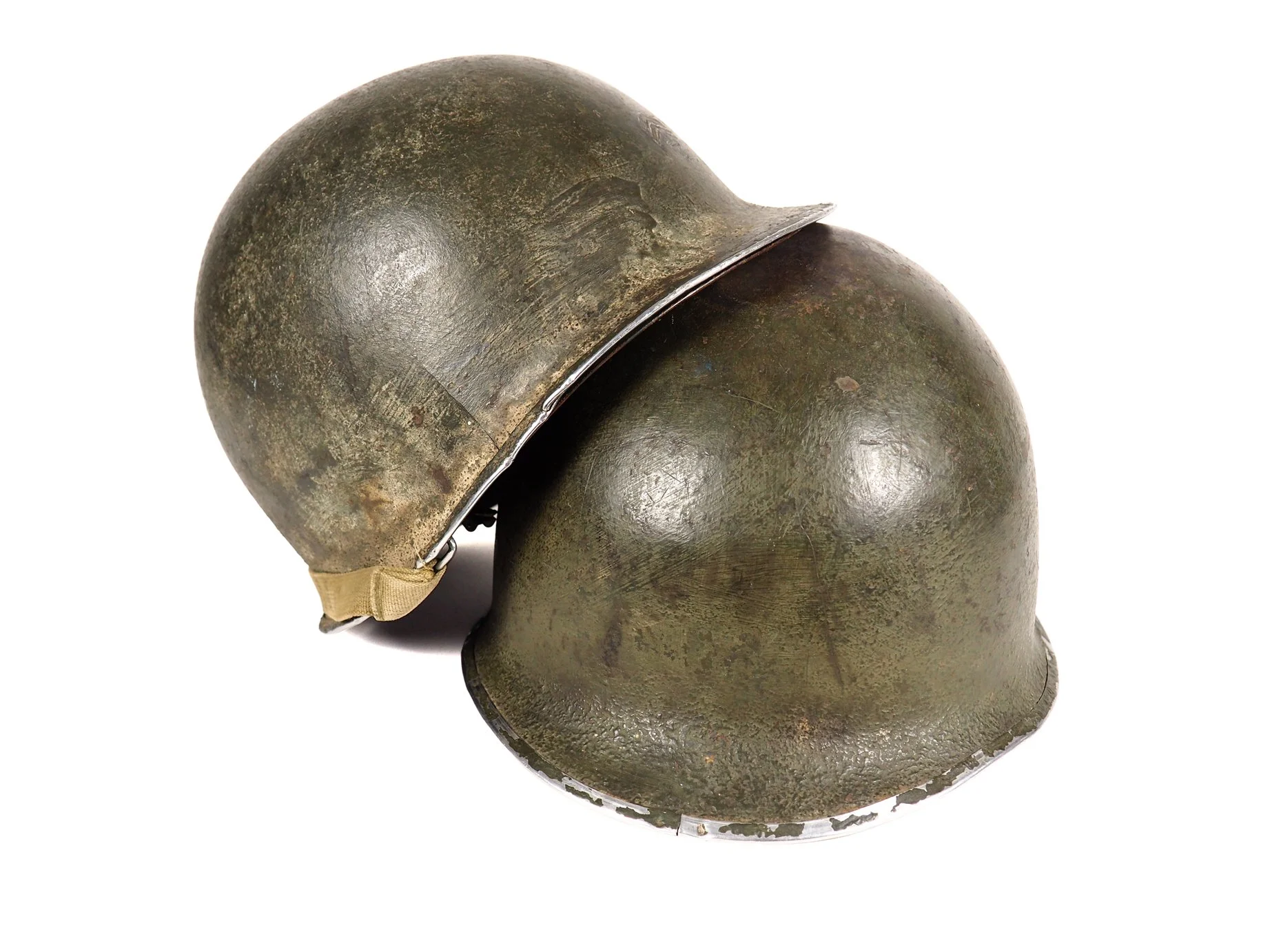 There is some continuity in the type of paint used on both of these 87th Division helmets as can be seen in this side by side comparison.